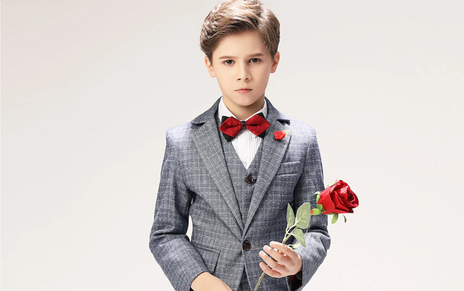 Stylish First Communion Outfit for Boys Featuring a Suit and Red Bow Tie with a Flower