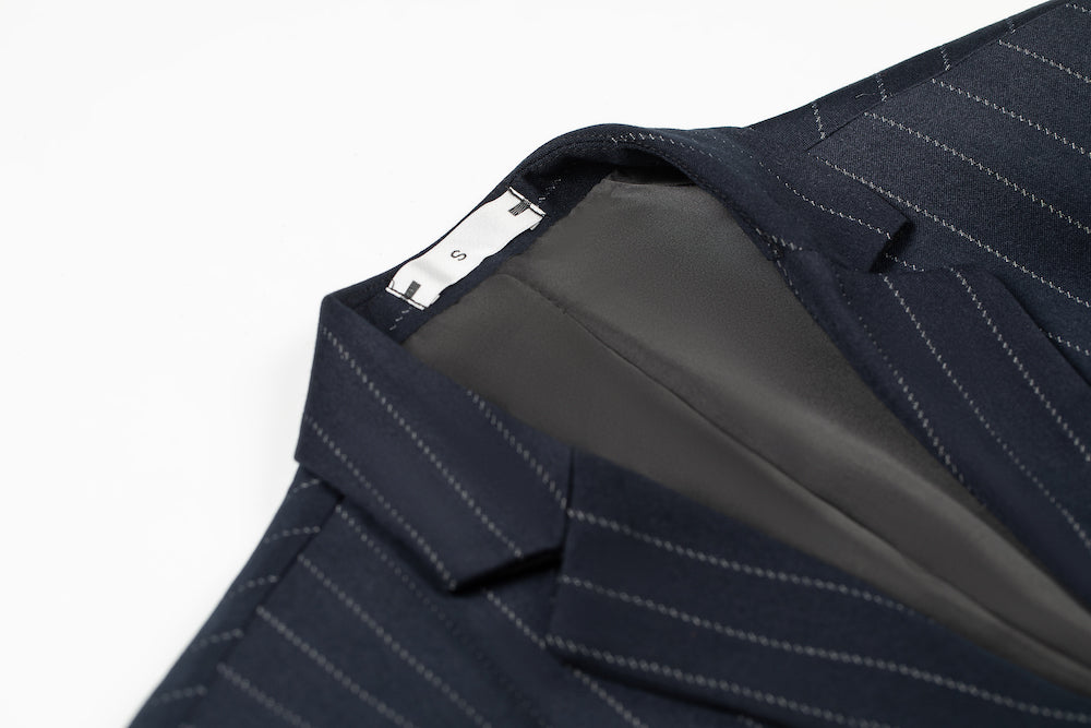Inner collar construction of navy pinstripe blazer with soft lining