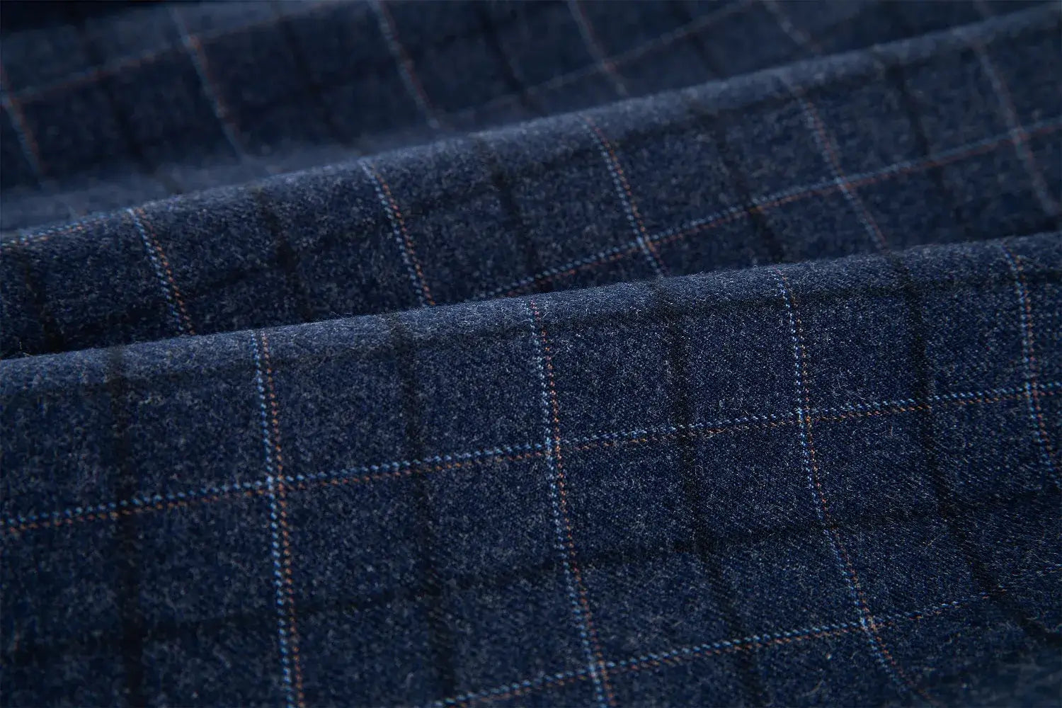 Detailed view of navy plaid fabric texture with blue and brown checks