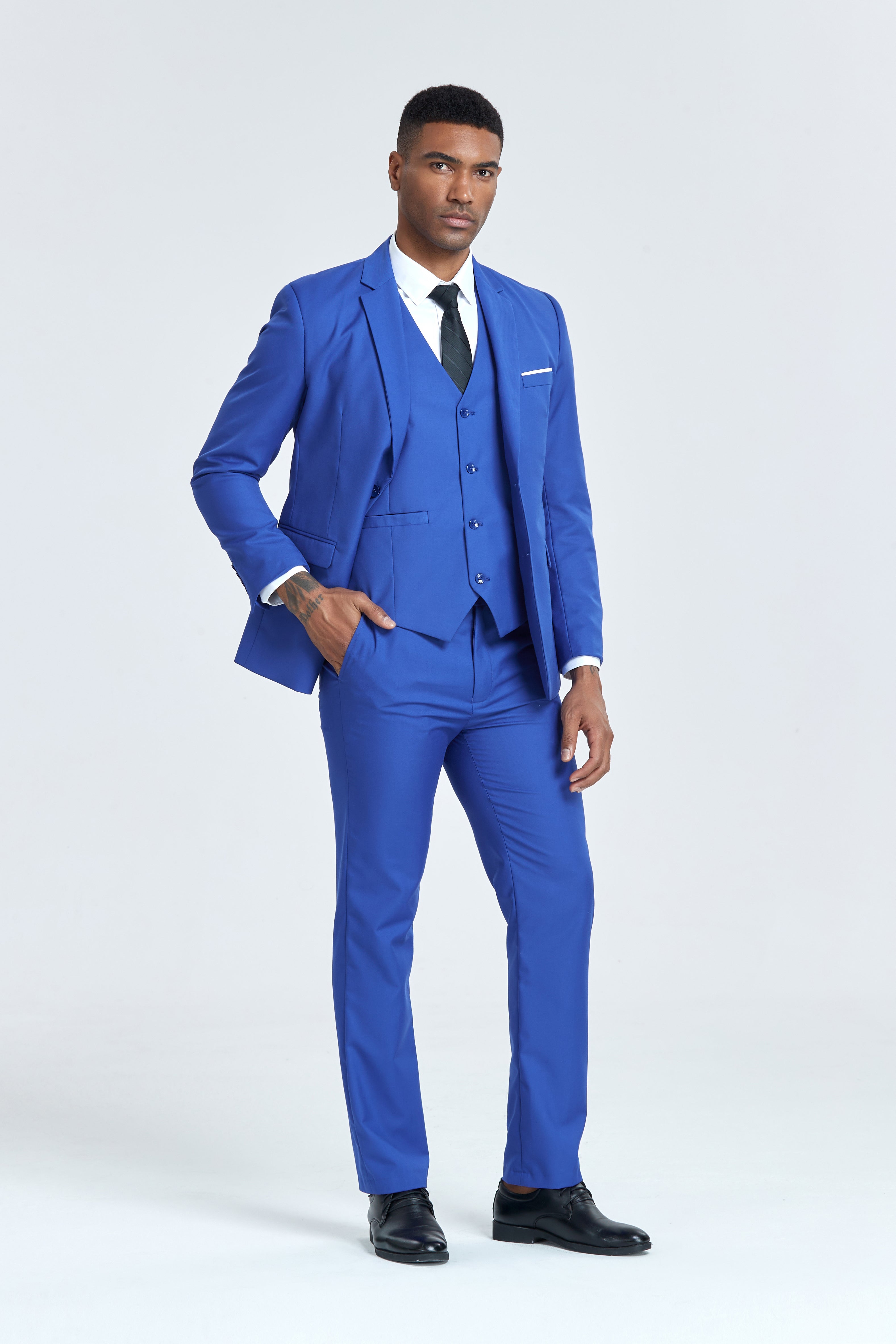 Model in royal blue formal suit with vest, posing with hand in pocket