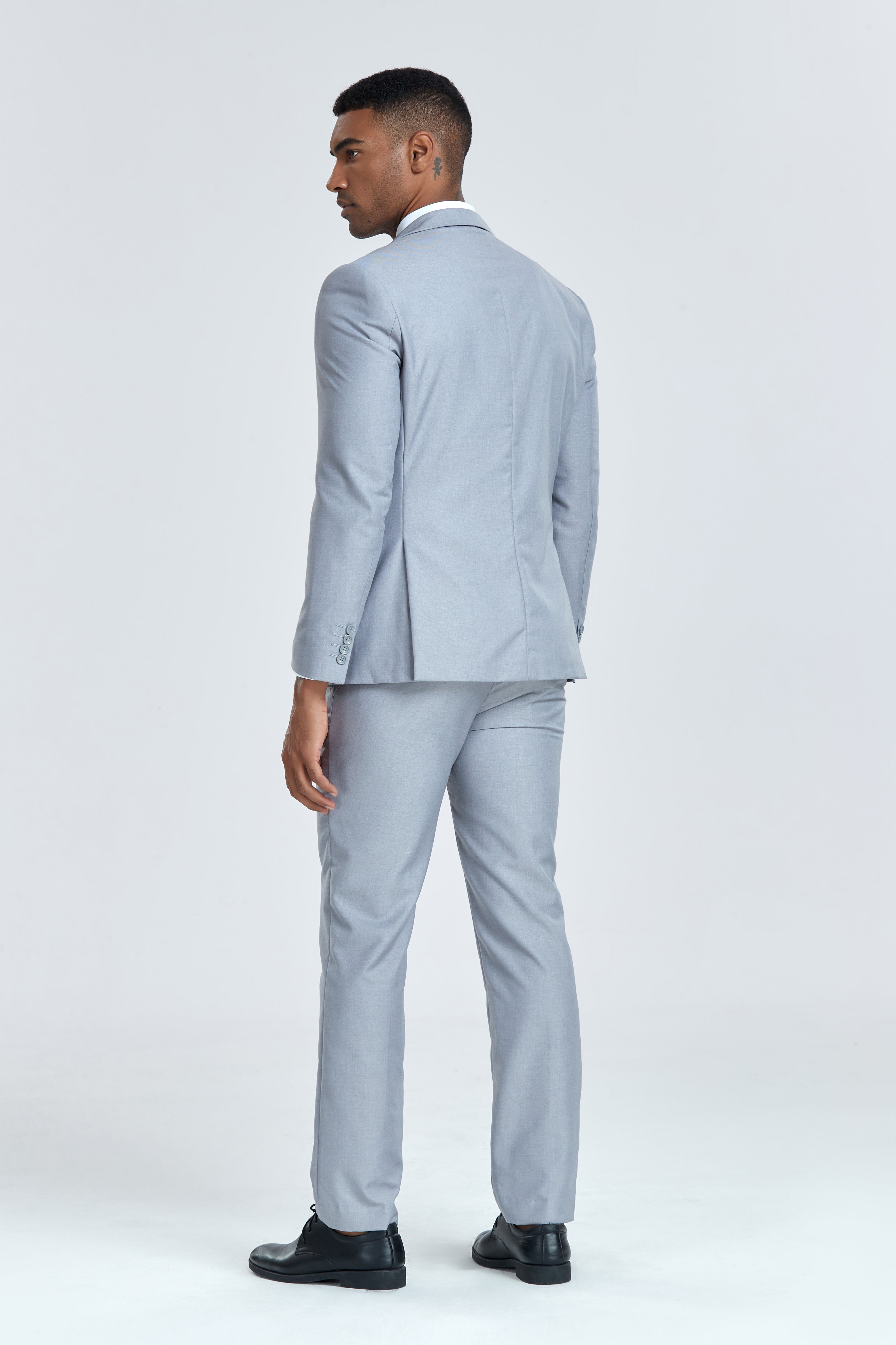 Back view of light grey men's 3 piece suit showcasing tailored fit for business occasions