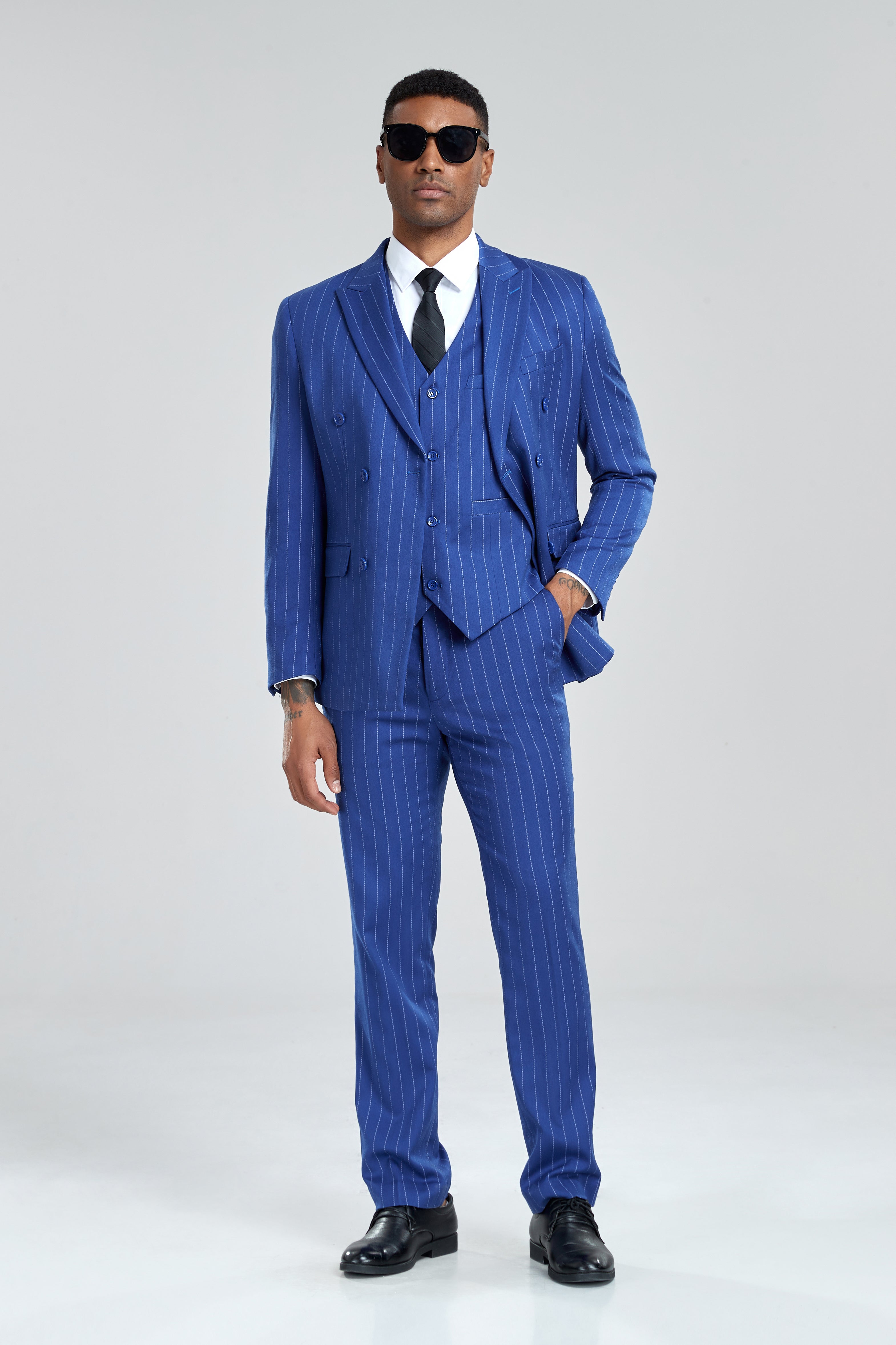 Bold royal blue 3 piece striped suit styled with sunglasses and tie