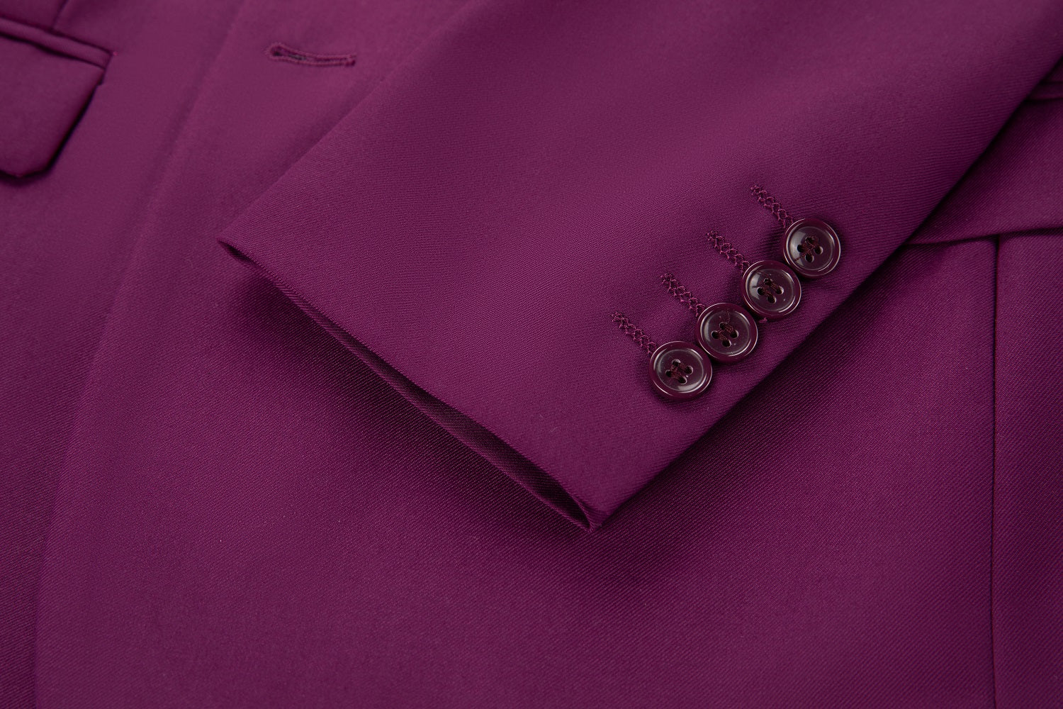 Men's purple two button blazer cuff detail - four matching purple buttons with stitched buttonholes on smooth fabric