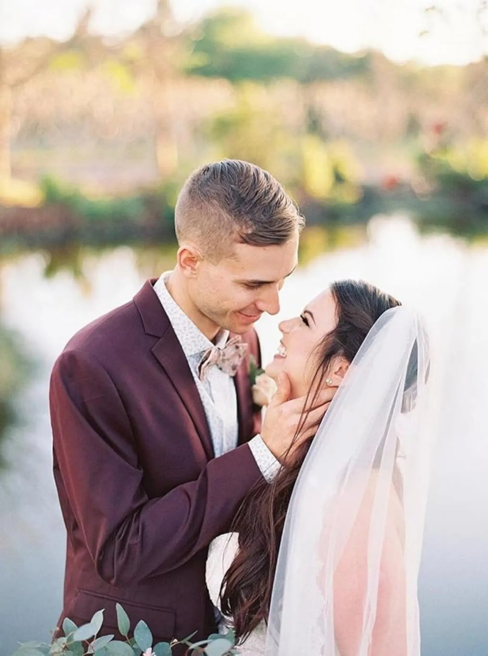 dark purple groom suit styled with bow tie for outdoor wedding by the water