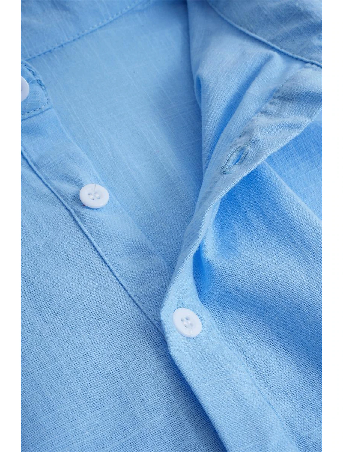 Button detail on blue casual linen shirt – soft breathable fabric with stitched placket for daily wear