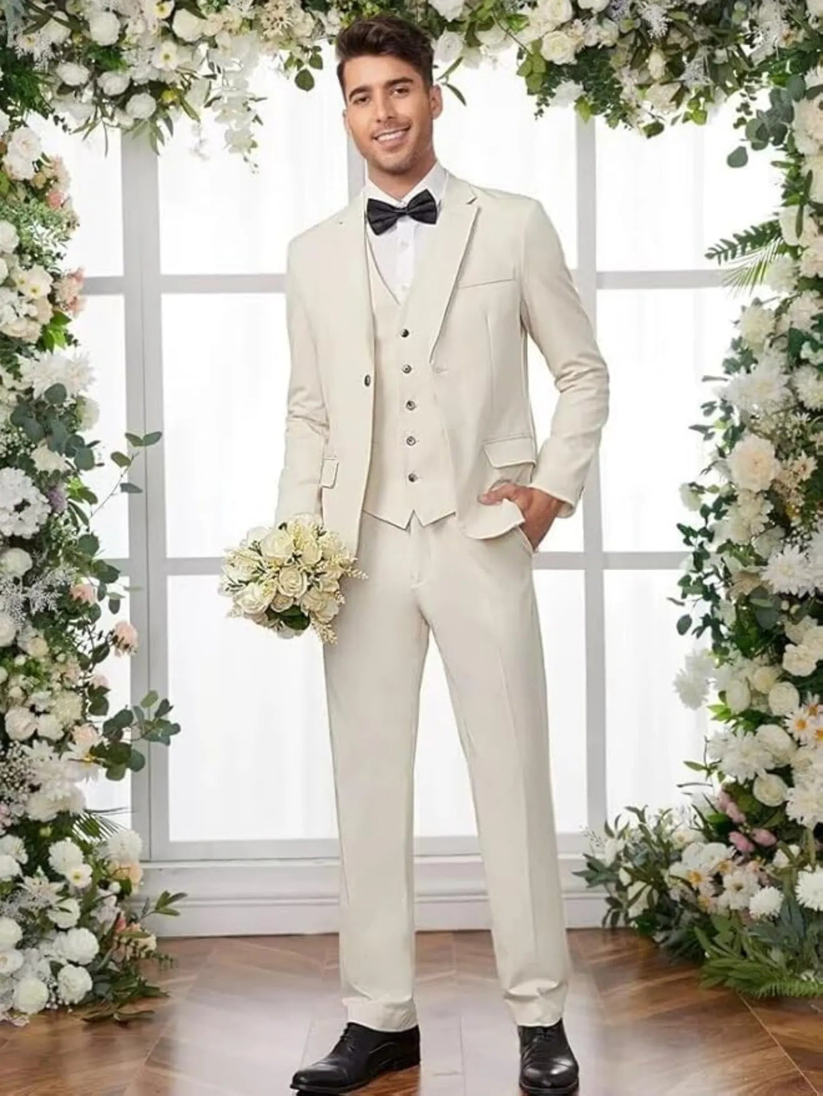 groom in ivory 3 piece slim tuxedo with bow tie for indoor wedding ceremony