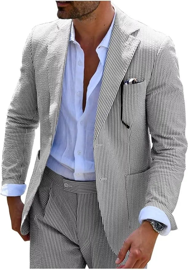 Man in black-and-white seersucker blazer, styled with an open collar shirt for a relaxed summer look.