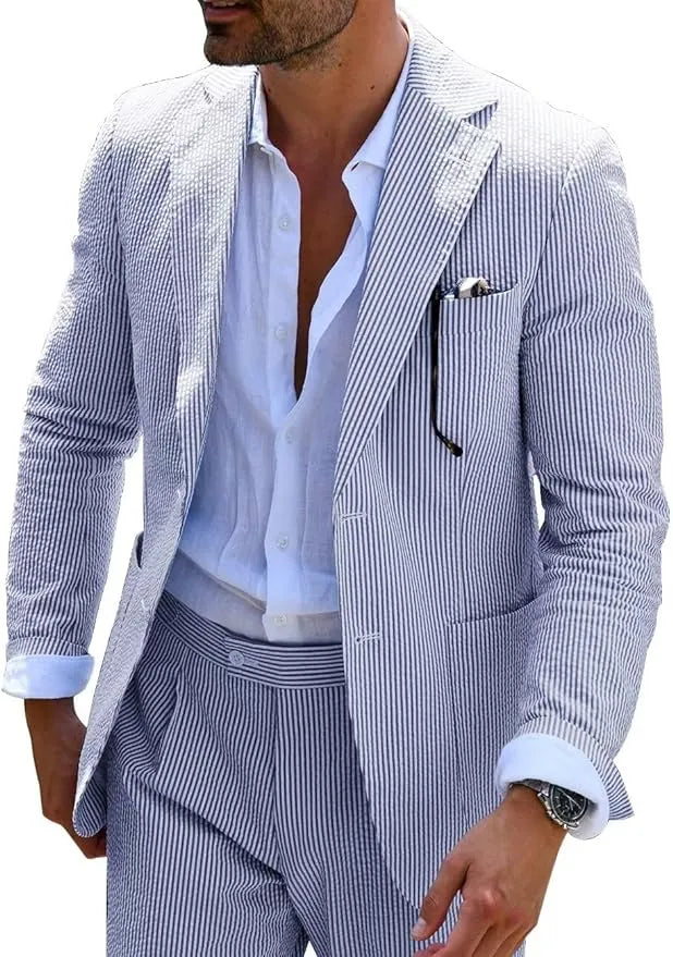 Man in blue-and-white seersucker blazer, styled with an open collar shirt for a relaxed summer look.