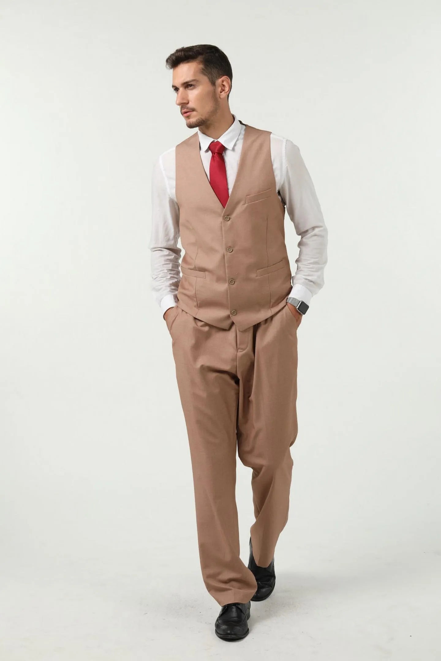 model wearing a champagne colored men's slim fit 3-piece vest and pants set with red tie, full-body front view.