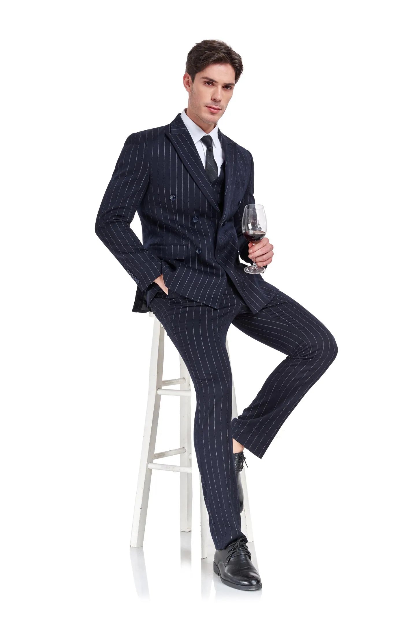 seated view of men's navy striped suit with vest, showcasing elegant formal style and double breasted blazer