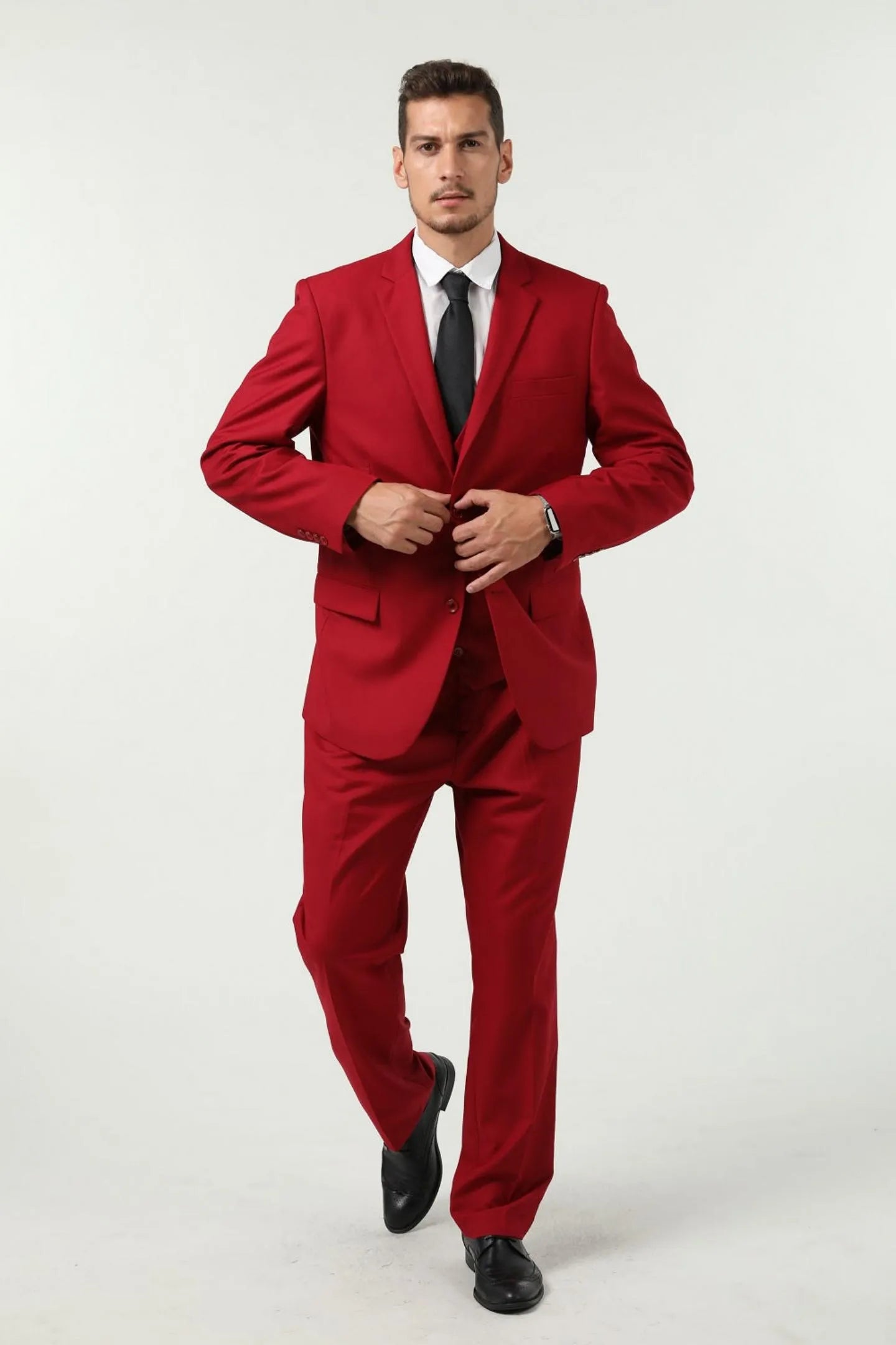full body front view of a man wearing a red slim fit two-button three-piece suit with a black tie – formal business look.