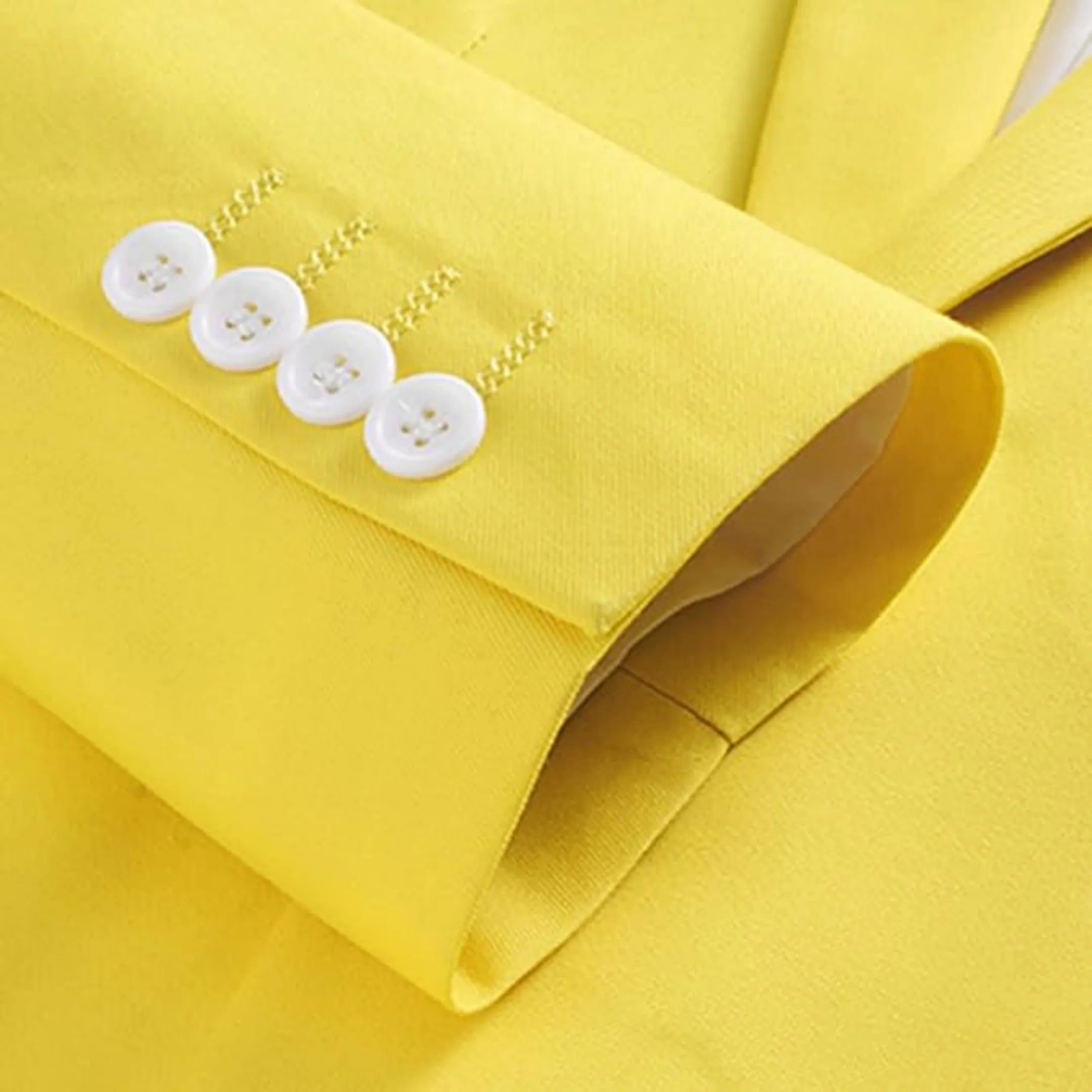 close-up of the tartrazine men's blazer sleeve showing four matching white buttons and neat stitching, highlighting the refined tailoring
