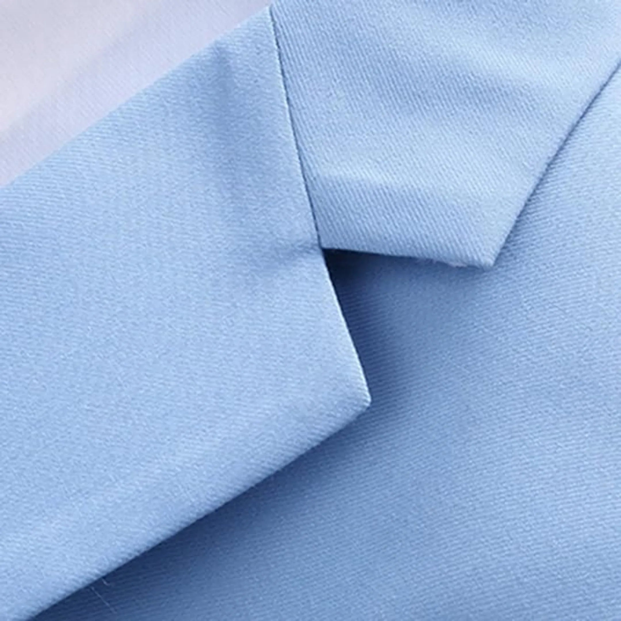 close-up view of the sky blue men's blazer collar and shoulder detailing, showcasing the tailored finish and high-quality fabric of the suit.