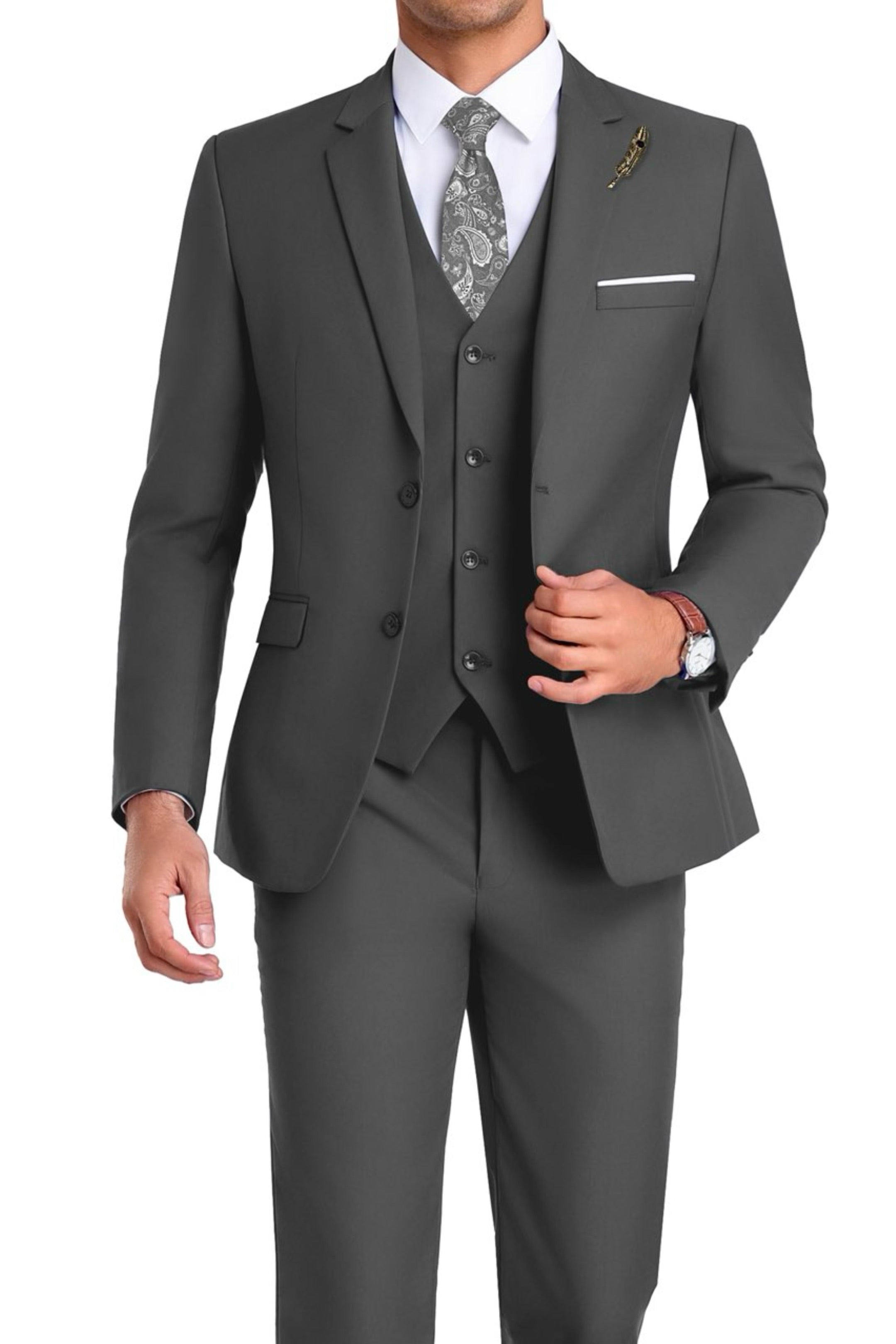 Model in dark grey 3-piece slim fit suit with paisley tie and white shirt, posing front-facing with one hand in motion