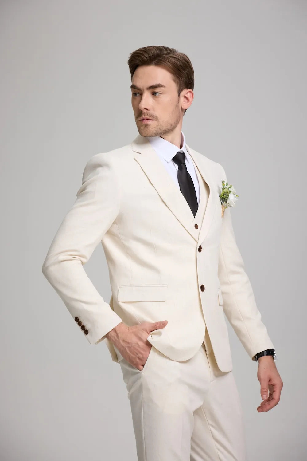 Side view of groom in beige linen suit – breathable summer wedding outfit with notch lapel and boutonniere