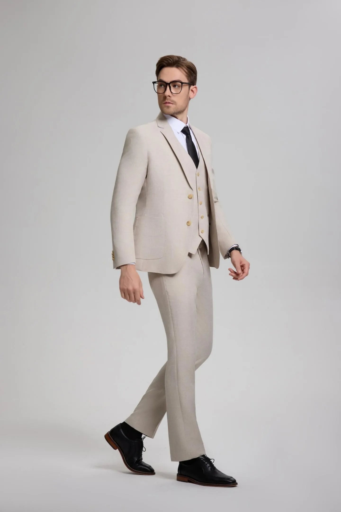 model walking confidently in a beige gray men's 3-piece suit – ideal for weddings, business meetings, and proms.