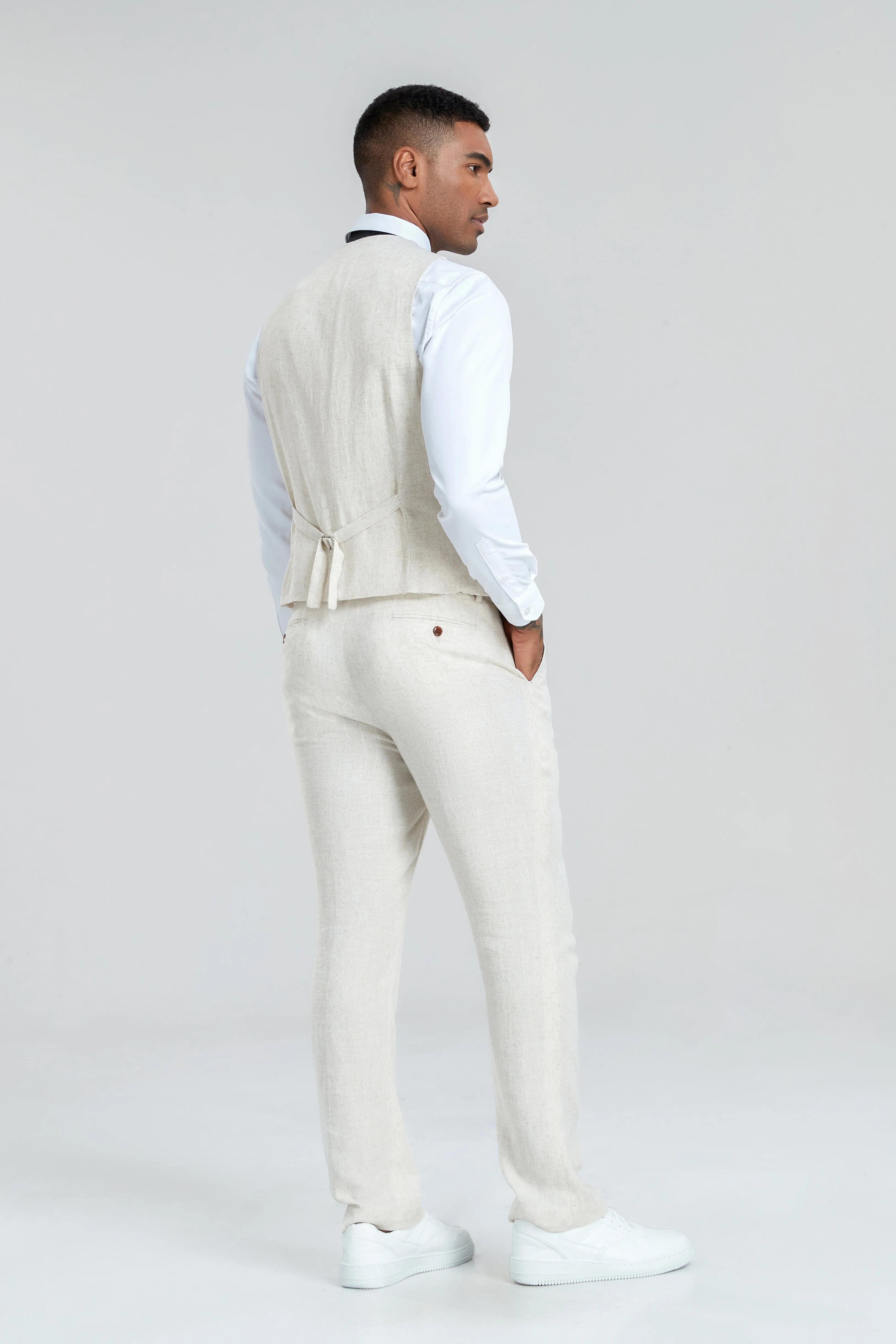 Back view of beige linen vest and trousers – adjustable waist detail on men's breathable summer suit