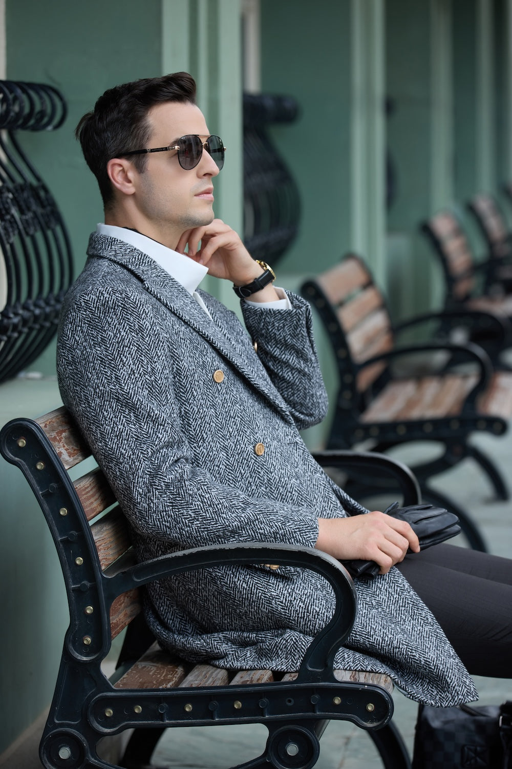 Black and white wool coat for men – seated styling with gloves and watch