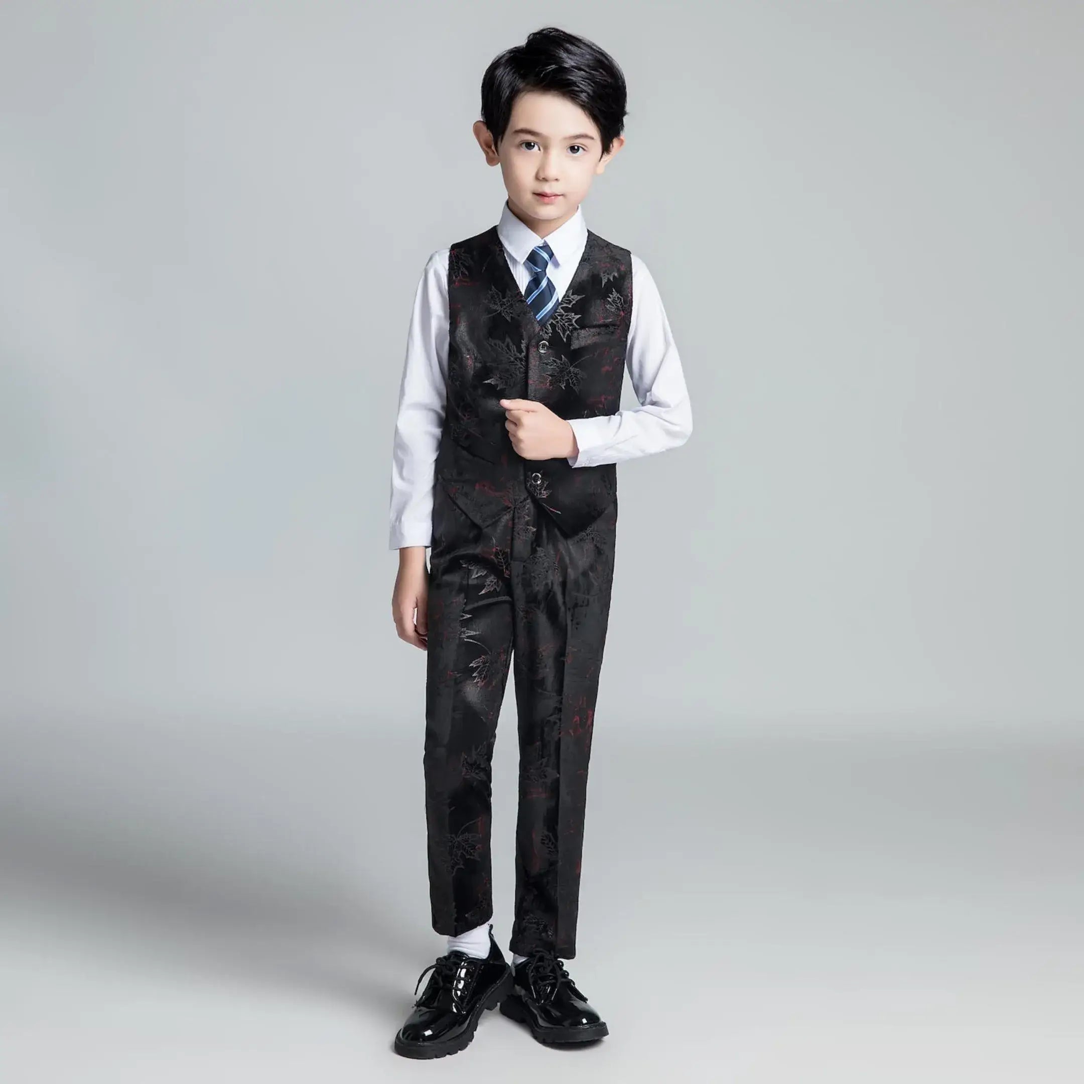 Black floral printed boys' vest and pants set with white shirt and striped tie, stylish outfit for graduation events