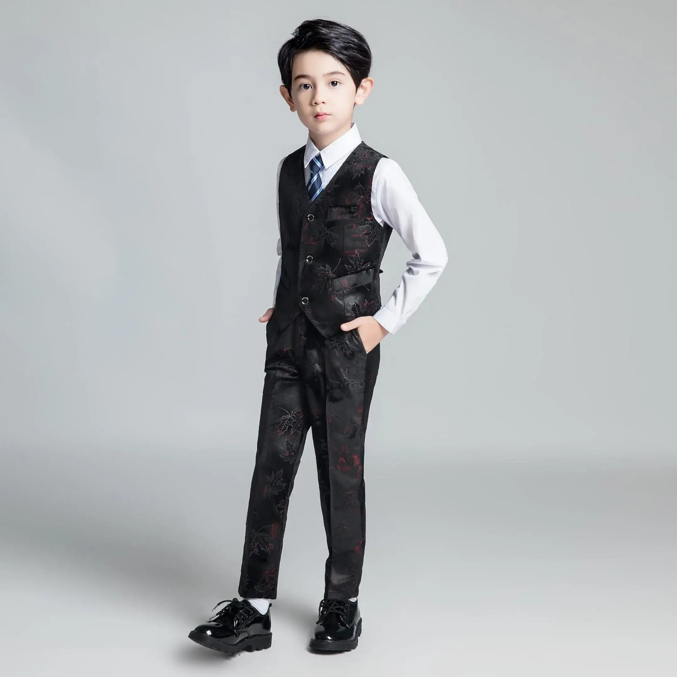 Elegant black floral boys' vest outfit with white shirt and blue striped tie, ideal for graduation or formal occasions