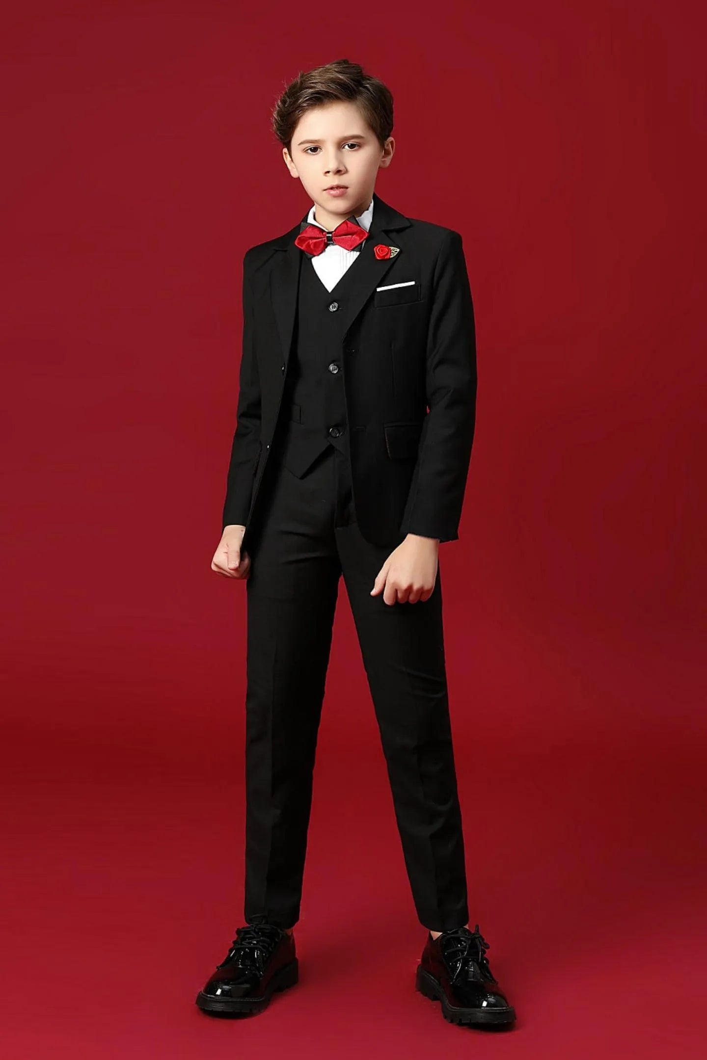 Stylish holiday boys suit 5-piece in black featuring a blazer, pants, vest, bow tie, and shirt