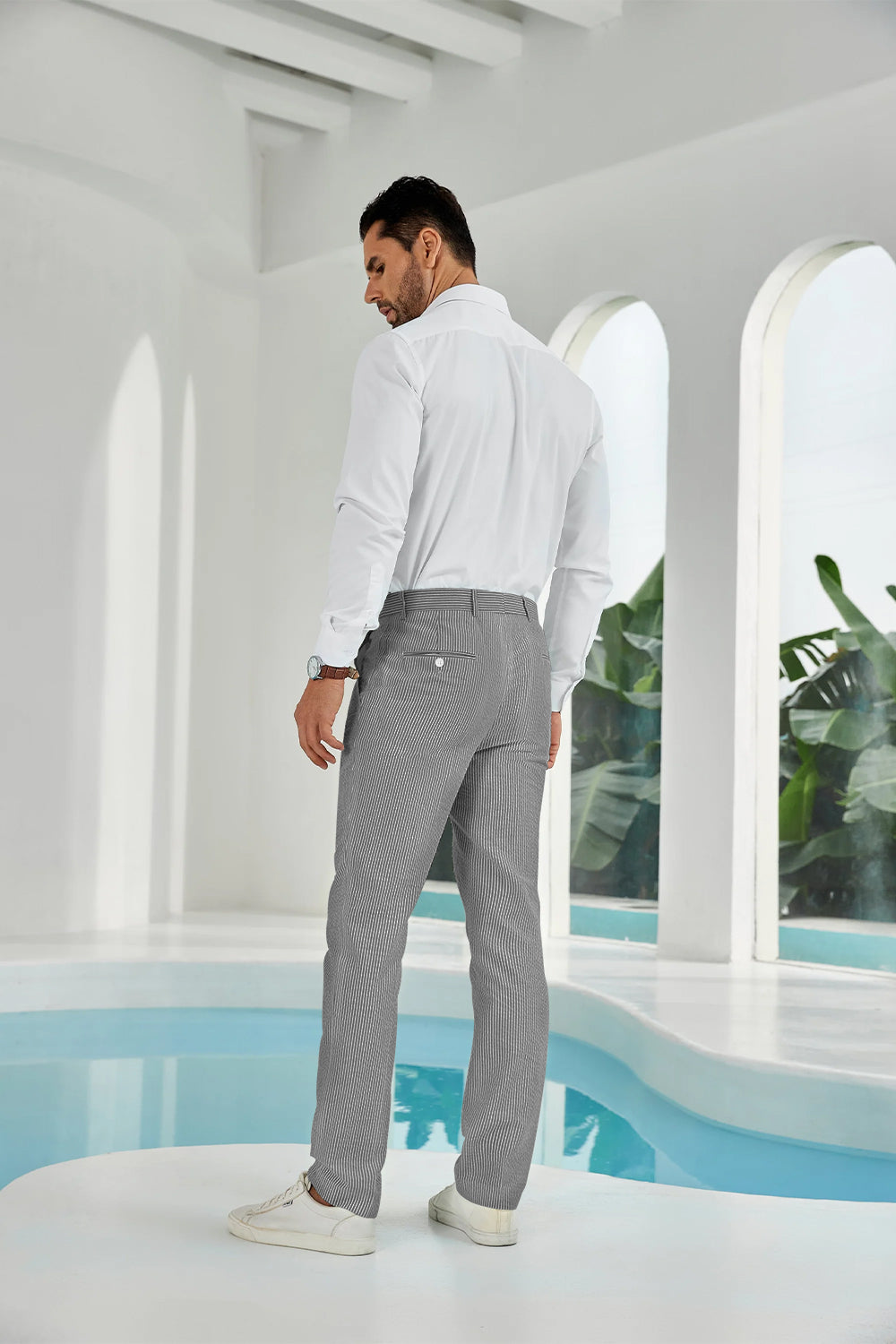 Three-quarter rear angle of black pants showing slim fit and texture