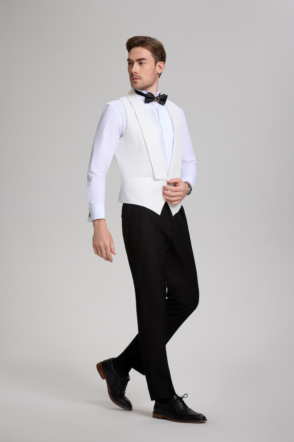 Side pose showing white shawl collar vest with black trousers – classic tuxedo set without jacket