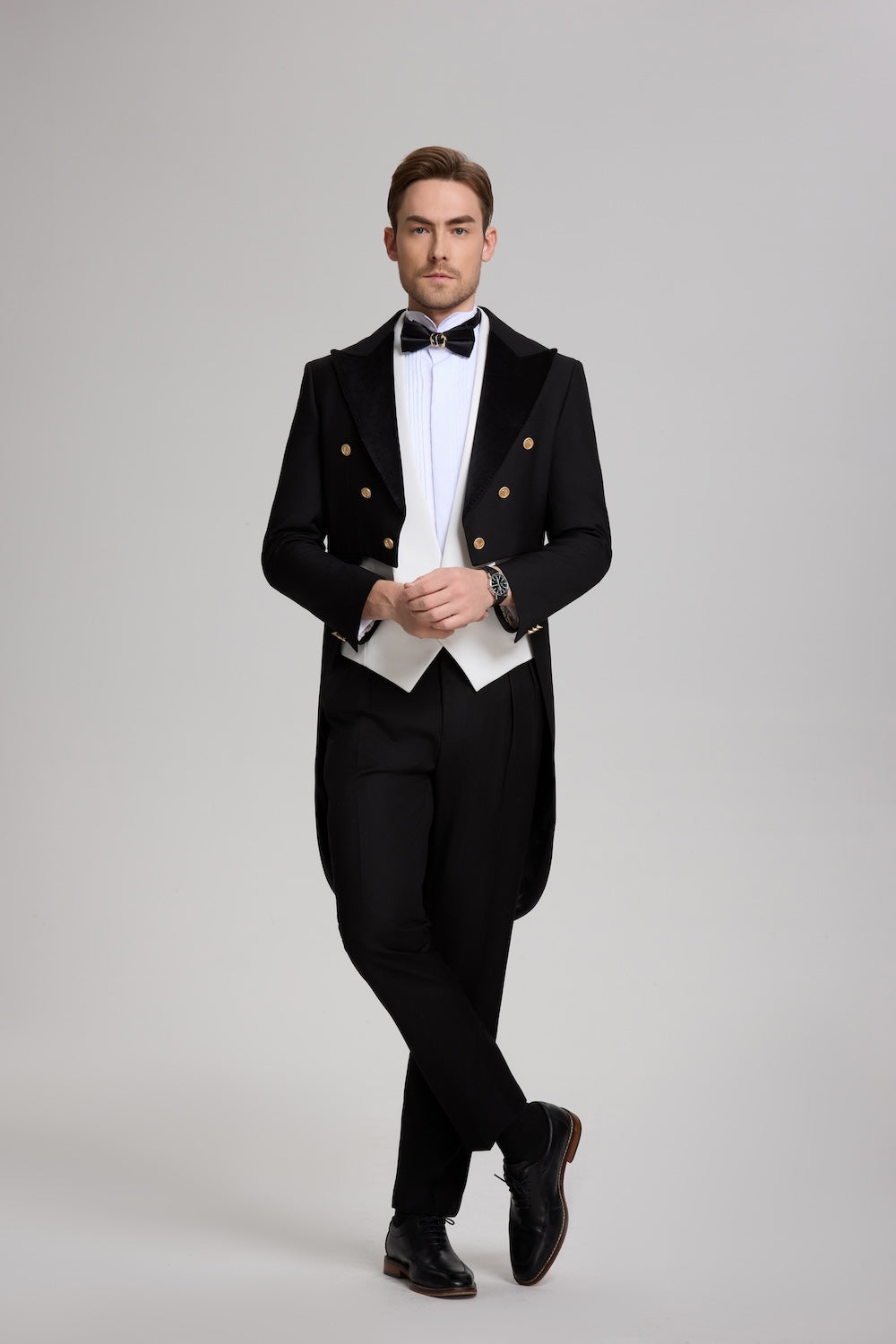 Front view of black peak lapel tuxedo with tailcoat and white vest – formal 3 piece evening suit