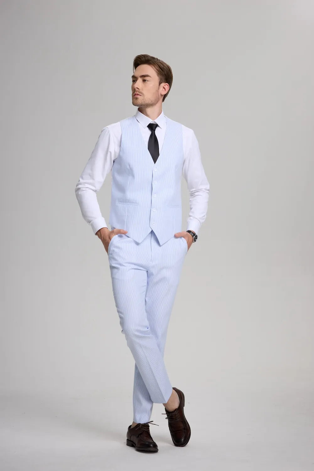 Front view of man in blue seersucker vest and pants, white shirt, and black tie