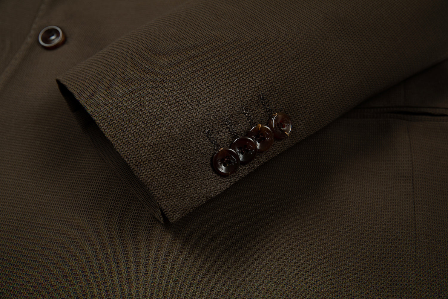 Designer brown double breasted blazer cuff detail - horn buttons with embroidered seam on textured fabric