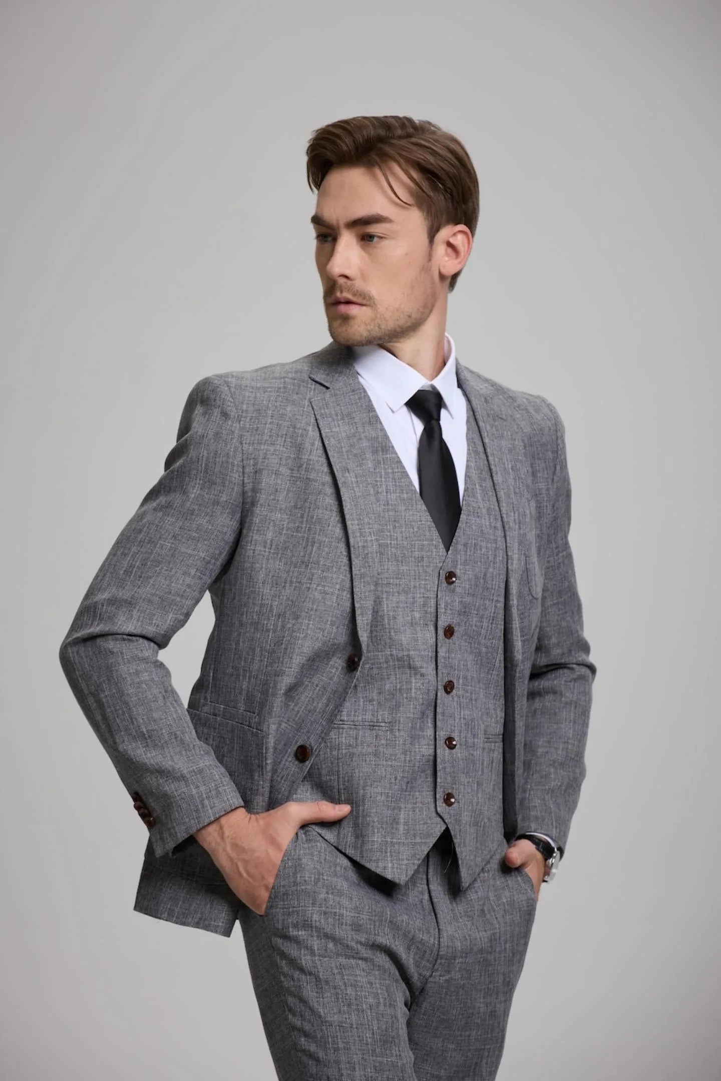 close-up of men's dark grey 3-piece suit – showcasing the sharp, tailored vest and blazer for formal events.