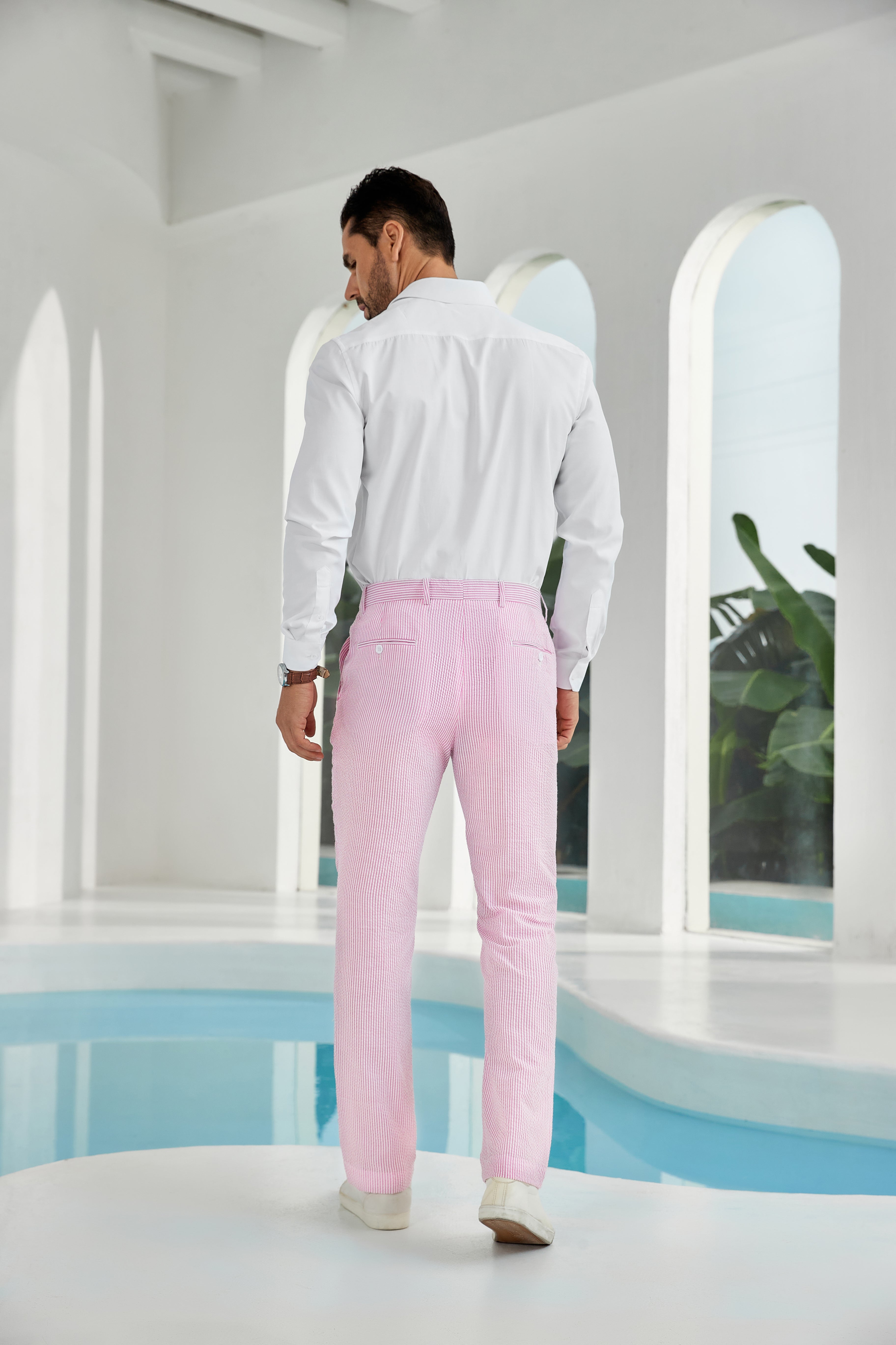 Three-quarter rear angle of dark pink pants showing slim fit and texture