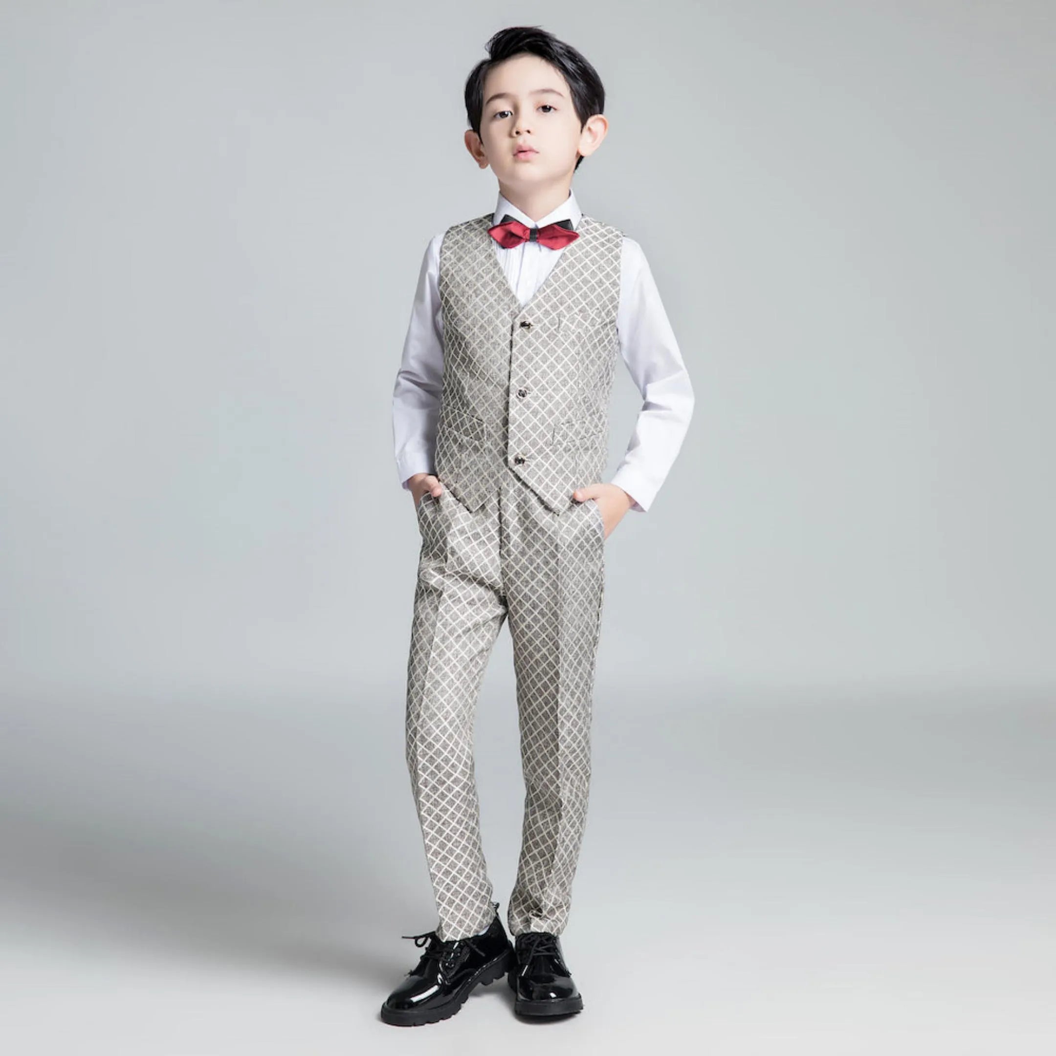 Elegant boys' formal vest and pants set with geometric print and red bow tie for weddings or parties