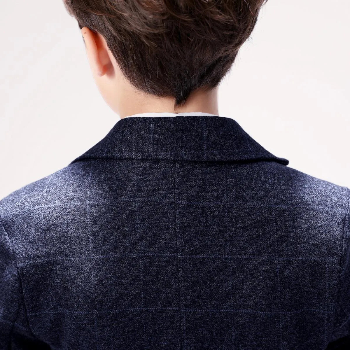 Back view of boys' plaid prom suit showcasing soft woolen texture and structured collar