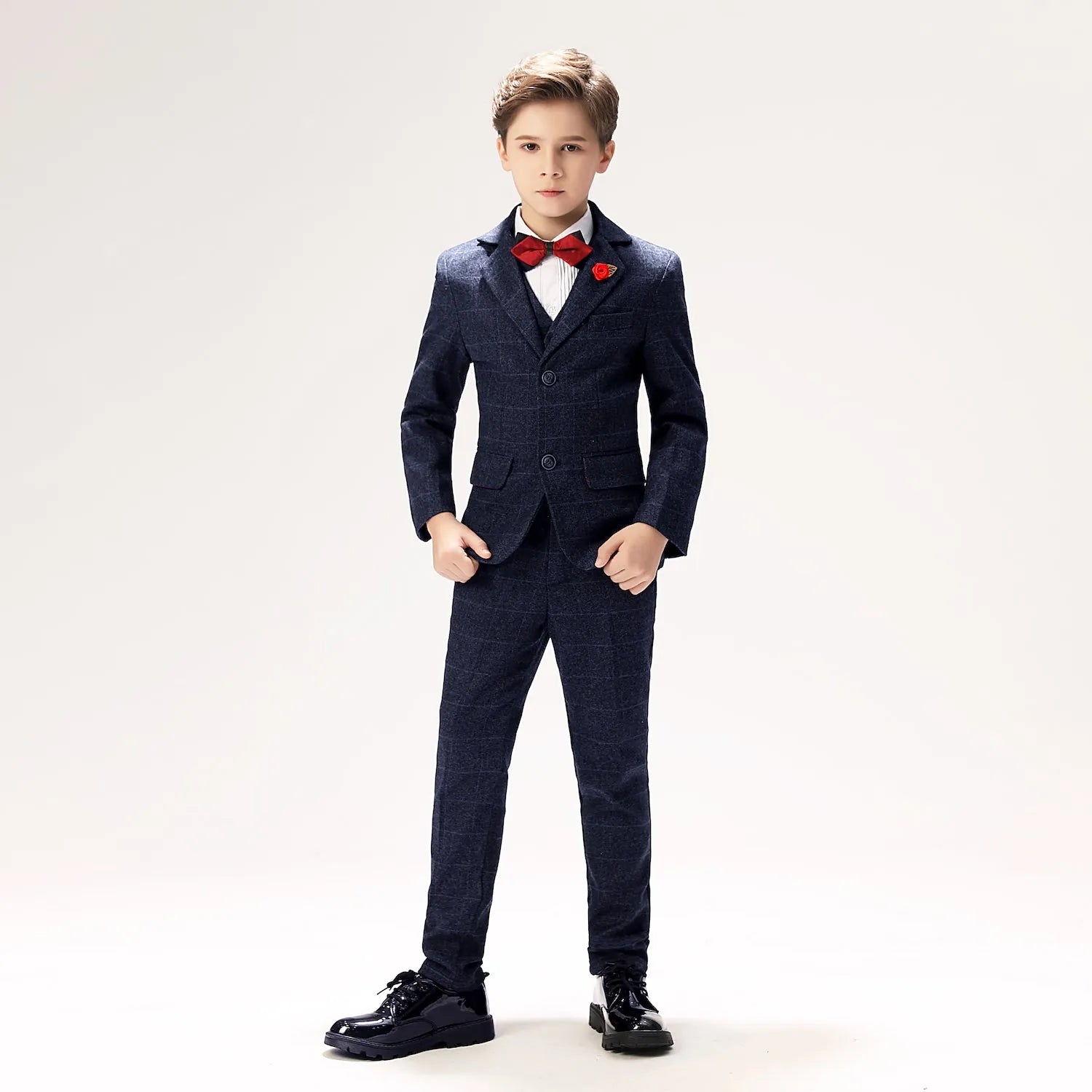 Plaid navy boys' prom suit with red boutonniere and bow tie, elegant five-piece outfit for weddings and formal parties