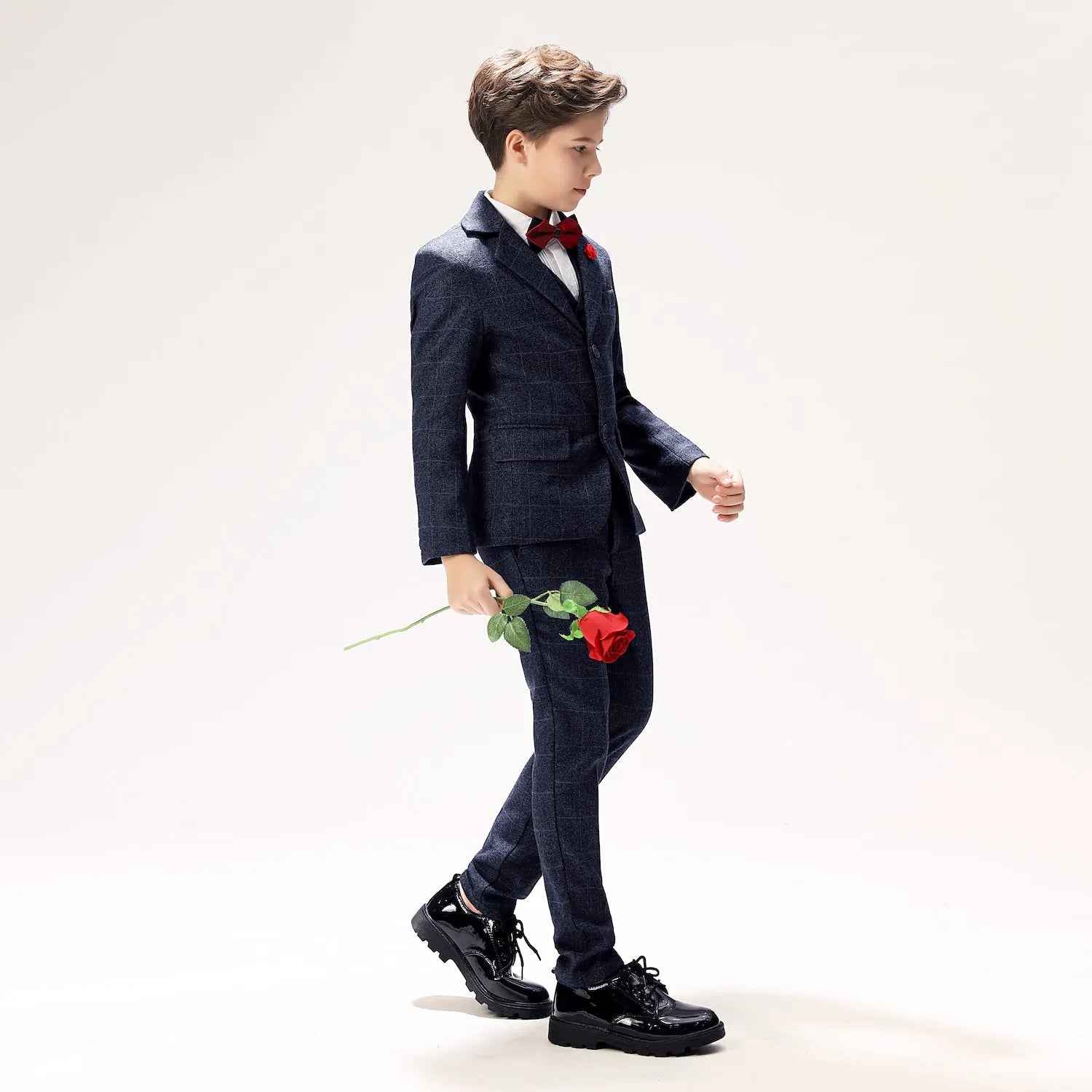 Navy plaid boys' prom suit with red bow tie and rose prop, stylish five-piece wool outfit for formal occasions