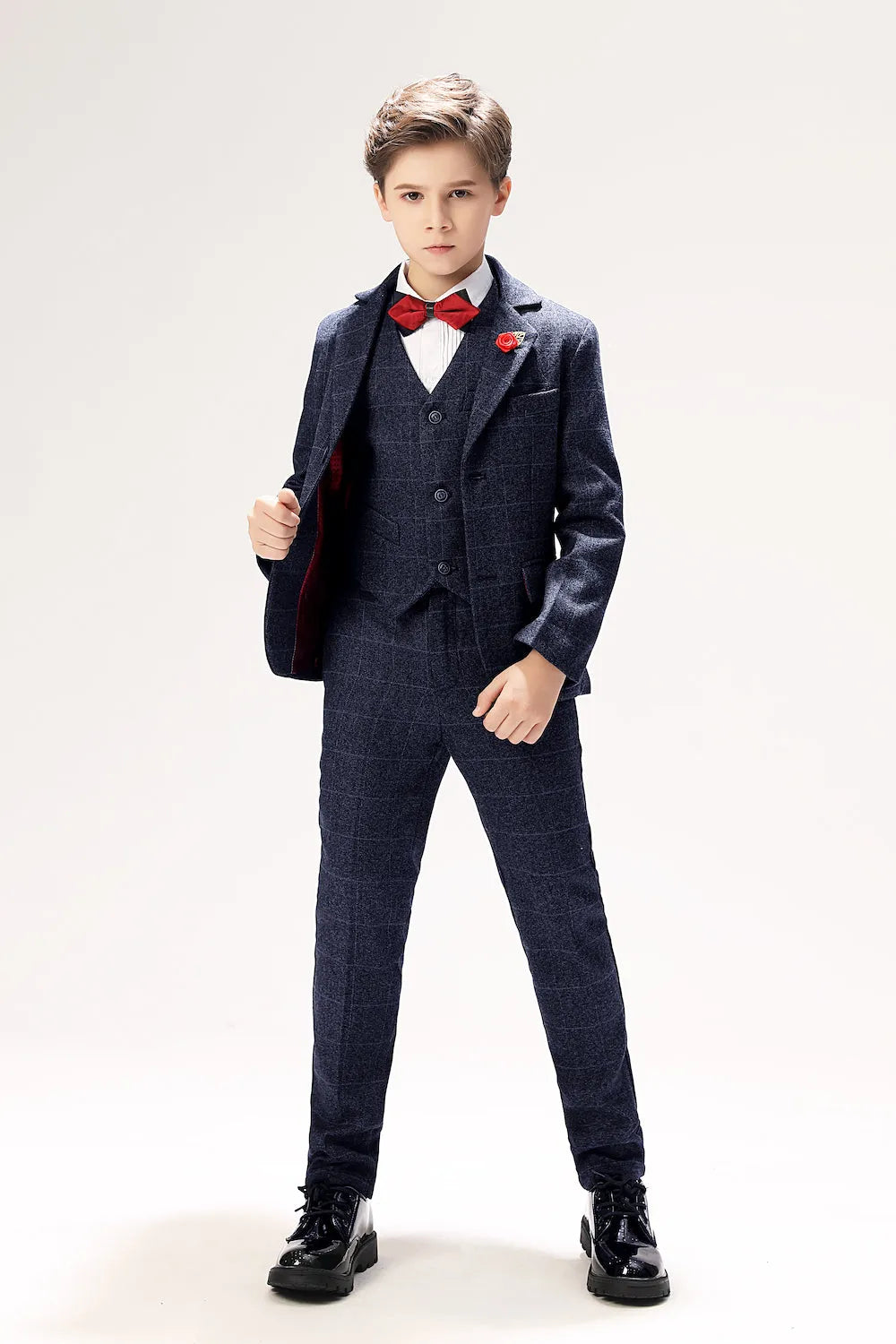 Elegant navy plaid boys' prom suit with red bow tie and floral lapel, five-piece formal outfit with classic wool texture