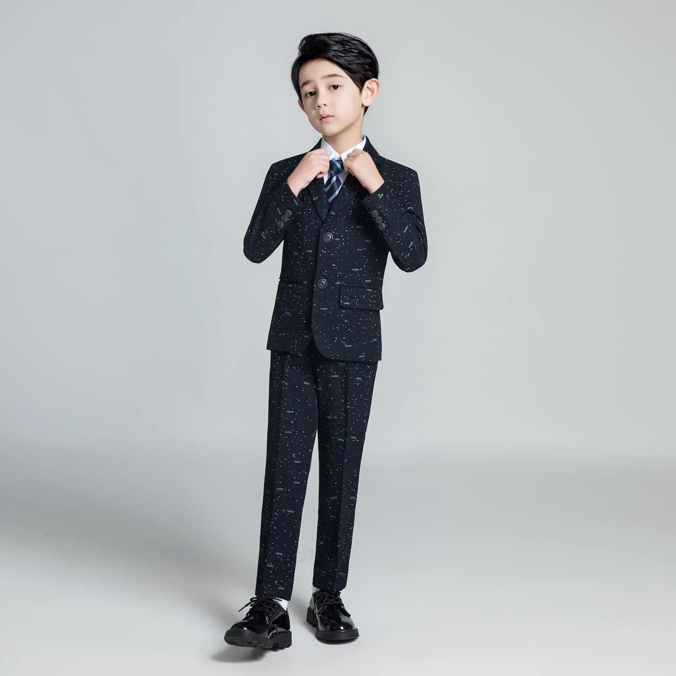 Printed boys' formal suit with modern slim fit, paired with striped tie and dress shoes for party or holiday occasions