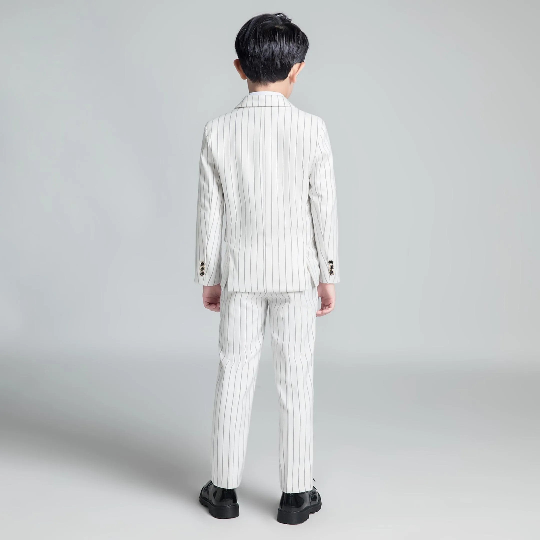 Back view of white striped boys formal blazer and trousers