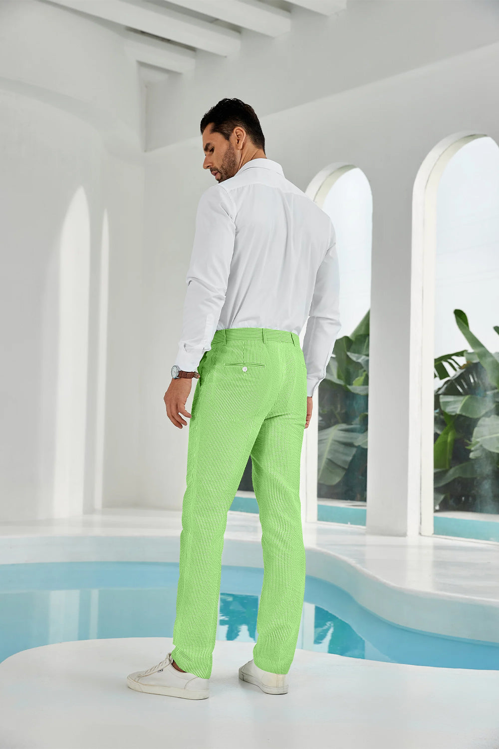 Three-quarter rear angle of green pants showing slim fit and texture
