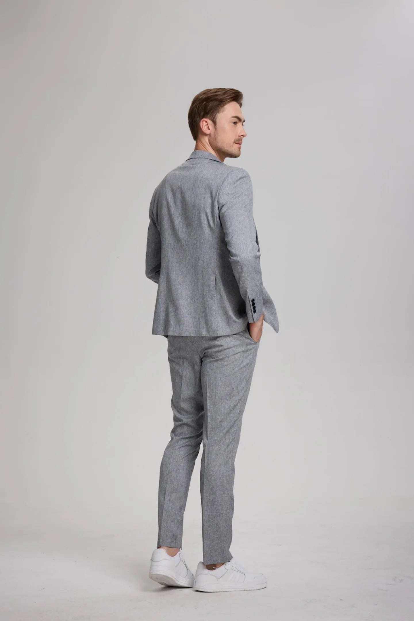 back view of men's grey lightweight slim fit 2-piece suit with notch lapel blazer and trousers, a sleek, modern look for smart-casual occasions.