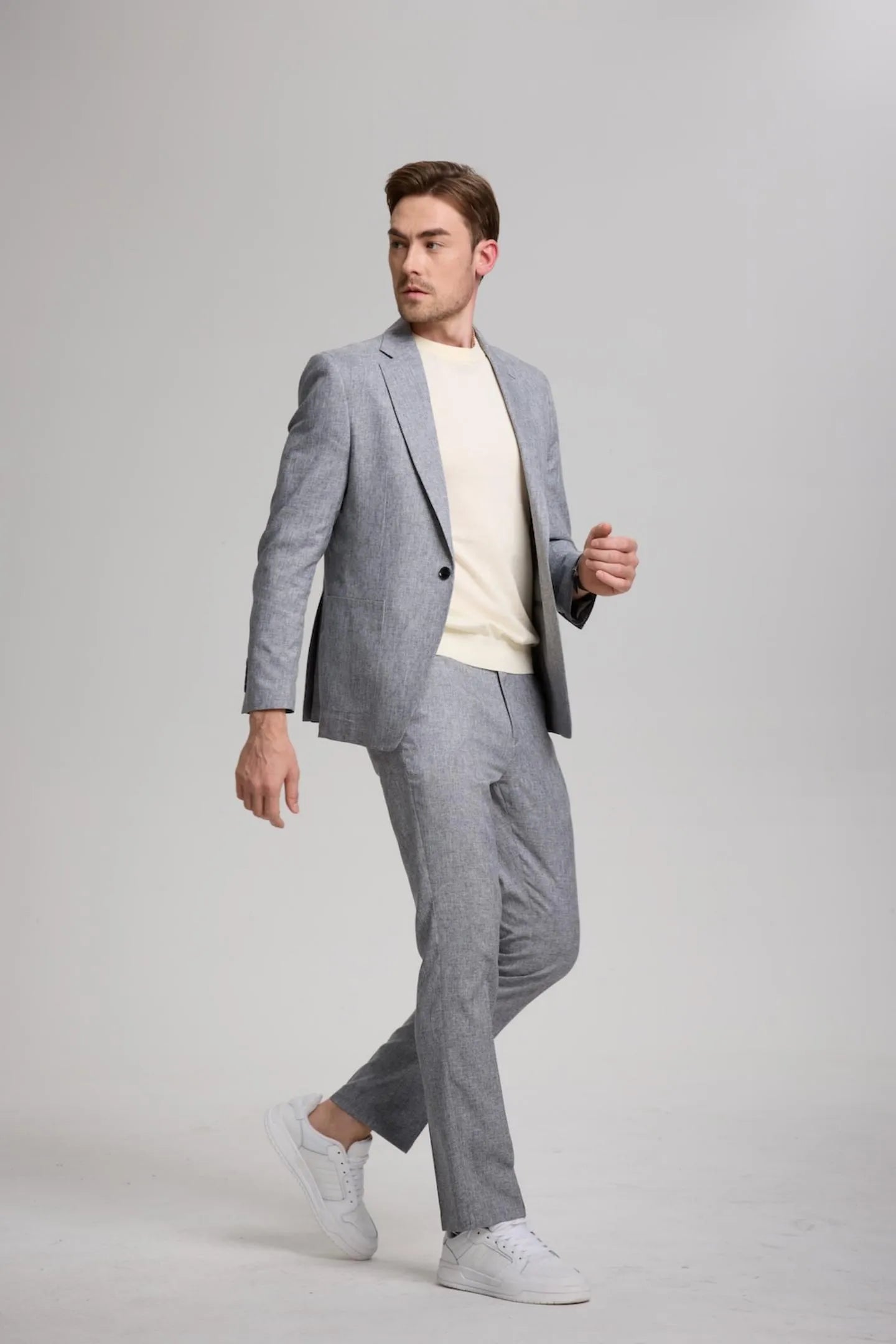 men walking in grey lightweight casual slim fit 2-piece suit with notch lapel blazer and trousers, ideal for weekend wear or casual business events.