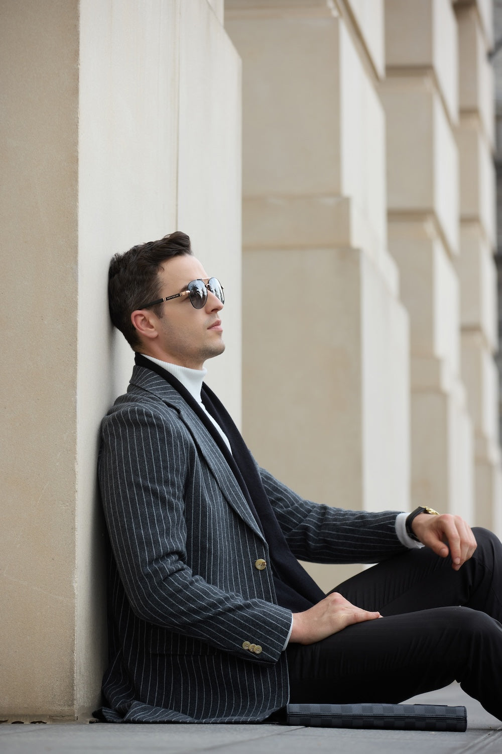 Grey wool dress coat for men – seated street pose in striped long overcoat