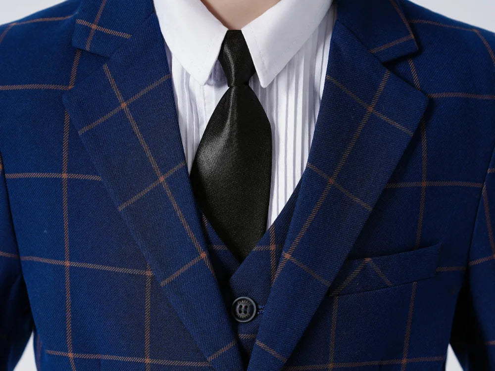 Close-up of blue check blazer with tie and shirt, highlighting boys smart school jacket styling and fabric texture.