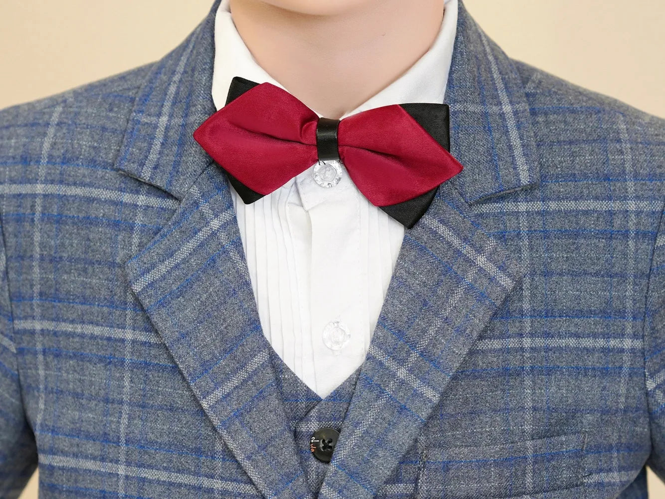 Boys formal plaid suit: Close-up of red bow tie on blue & white checked lapel
