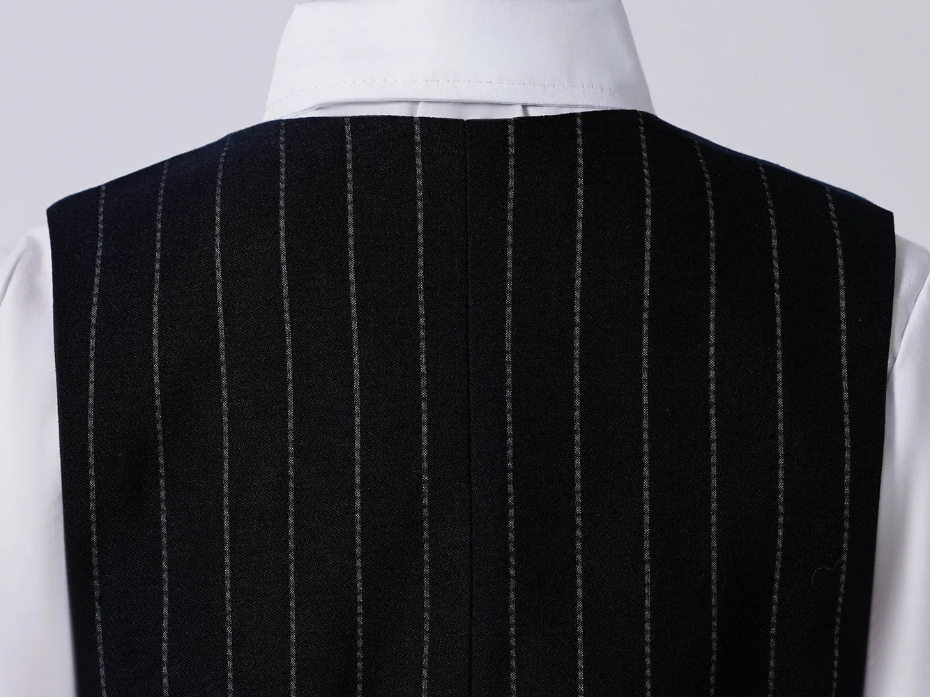 Back view of boys' navy pinstripe vest – tailored formalwear for weddings and parties