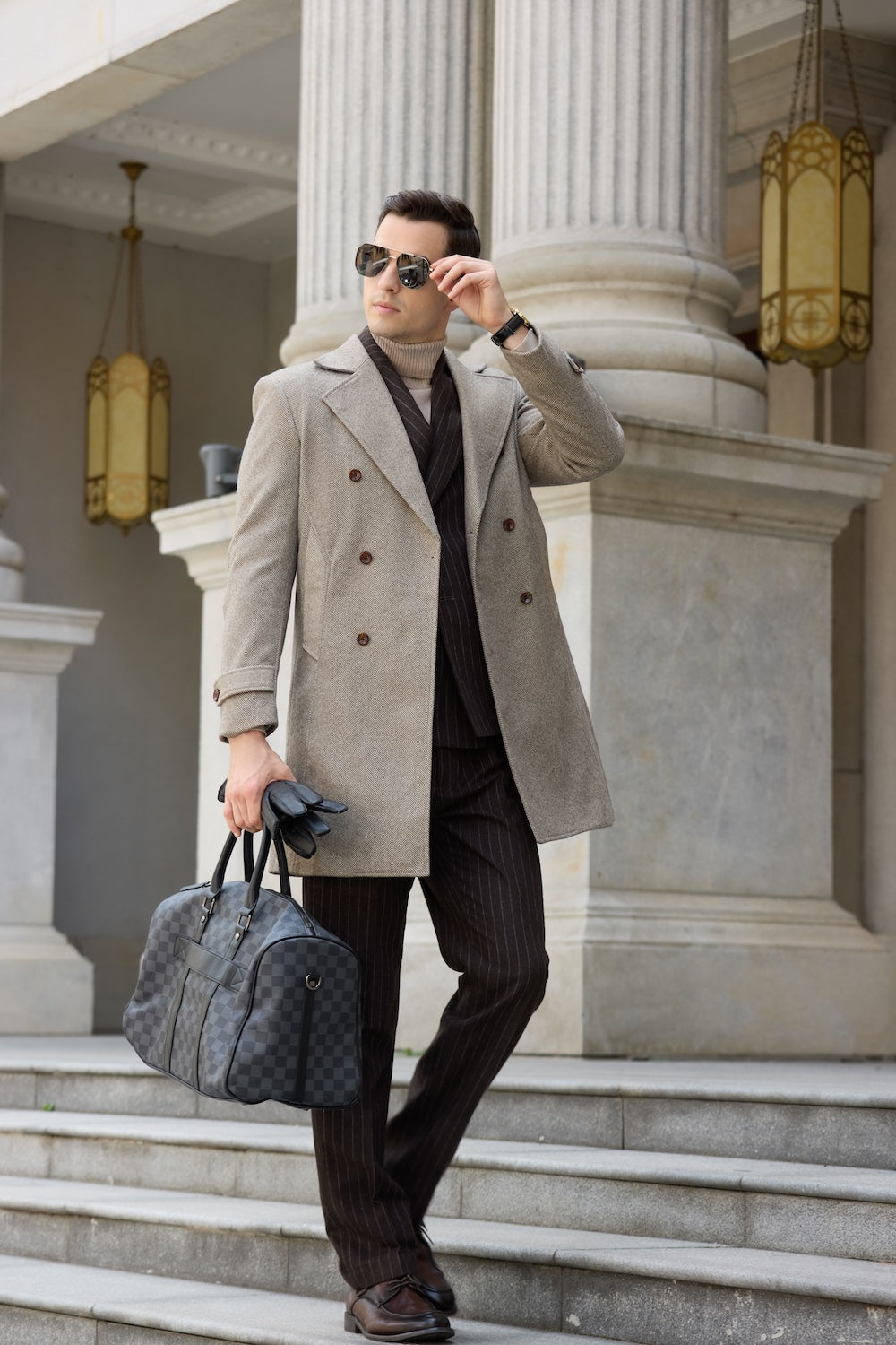 Men’s light coffee overcoat – walking pose with sunglasses and travel bag