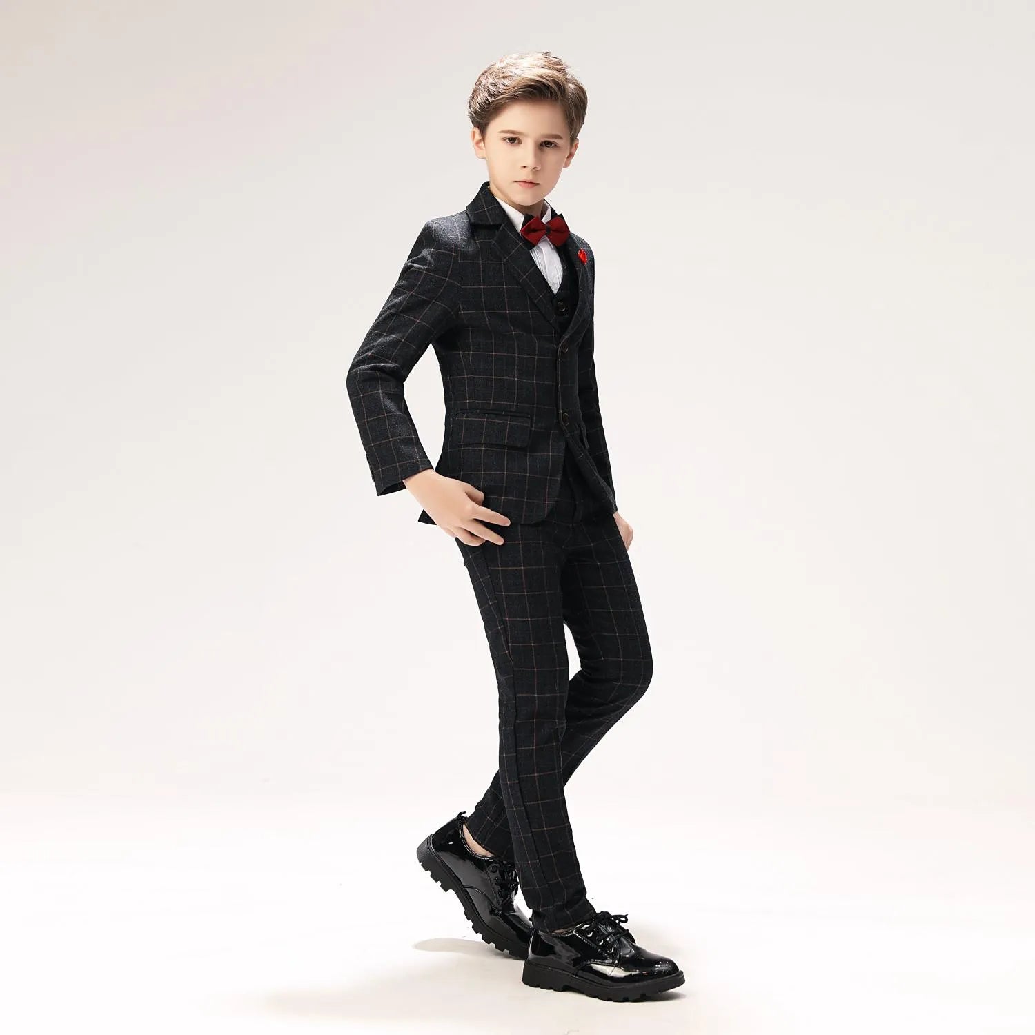 Stylish black plaid boys suit with red accents, classic 3 piece look for birthdays or weddings