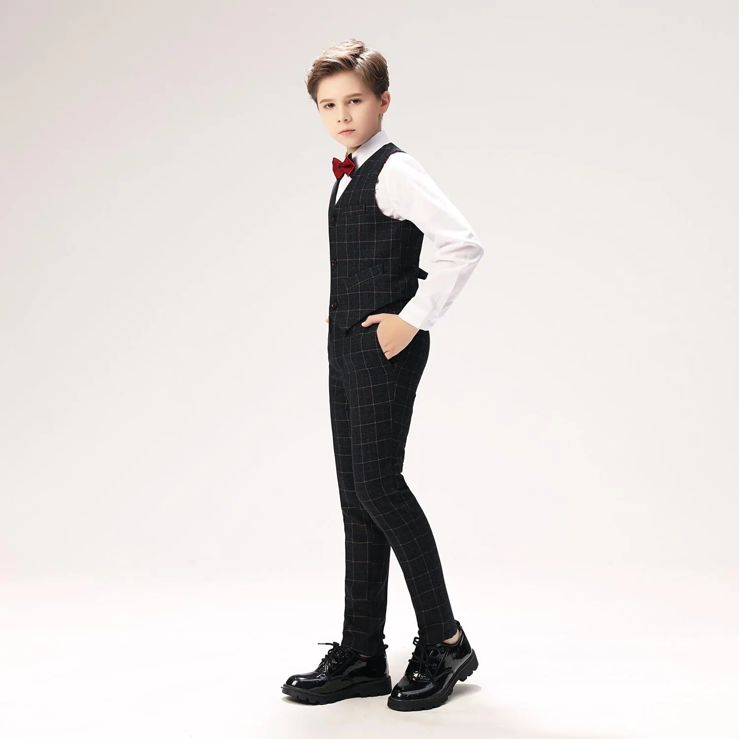 Side view of slim fit black checkered boys suit vest and pants, stylish formalwear for events