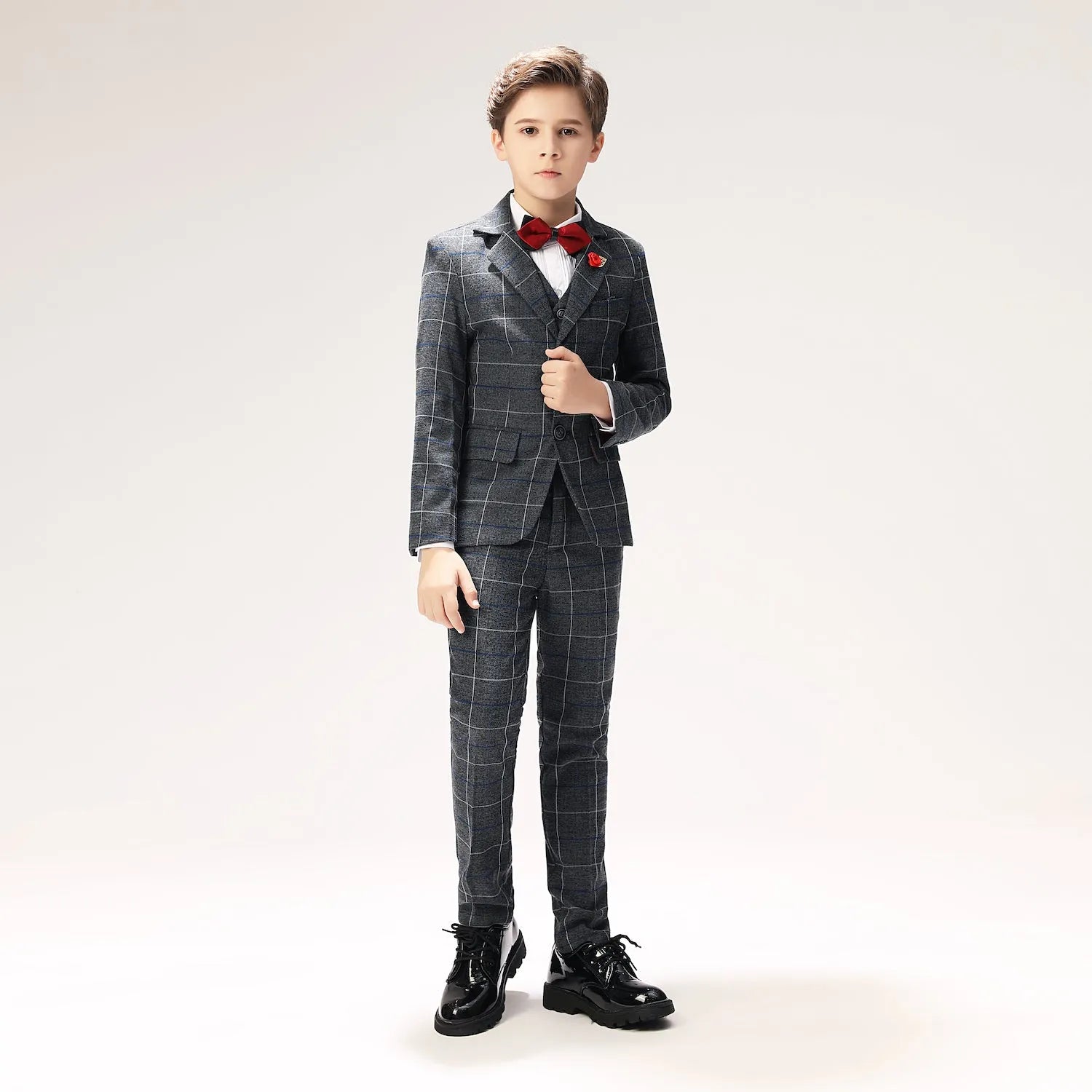 Full front view of boys formal dark plaid suit with slim fit trousers and jacket